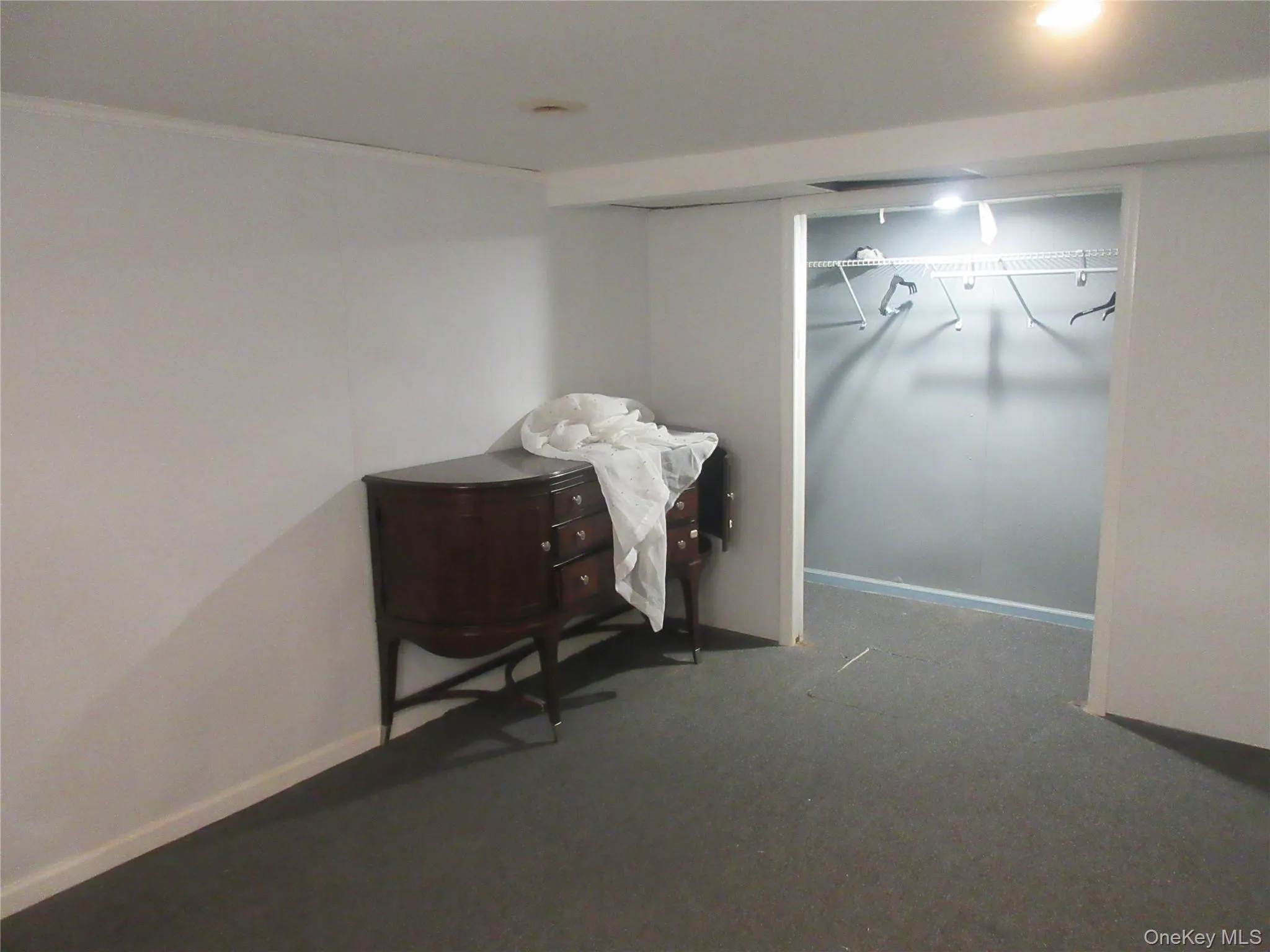 Bedroom with carpet, a closet, and ornamental molding Bedroom with carpet, a closet, and ornamental molding