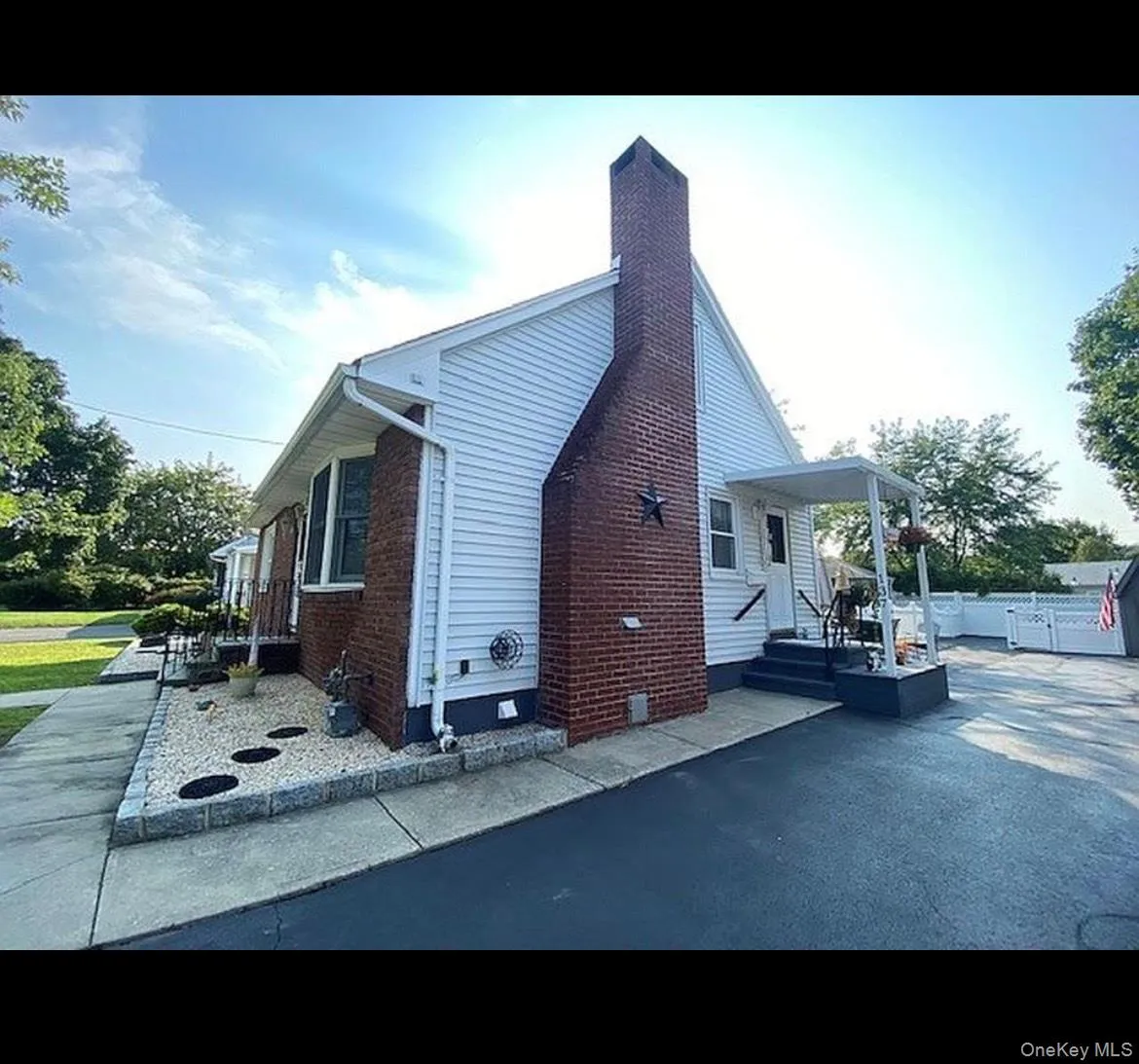 View of home's exterior with a chimney and brick siding View of home's exterior with a chimney and brick siding