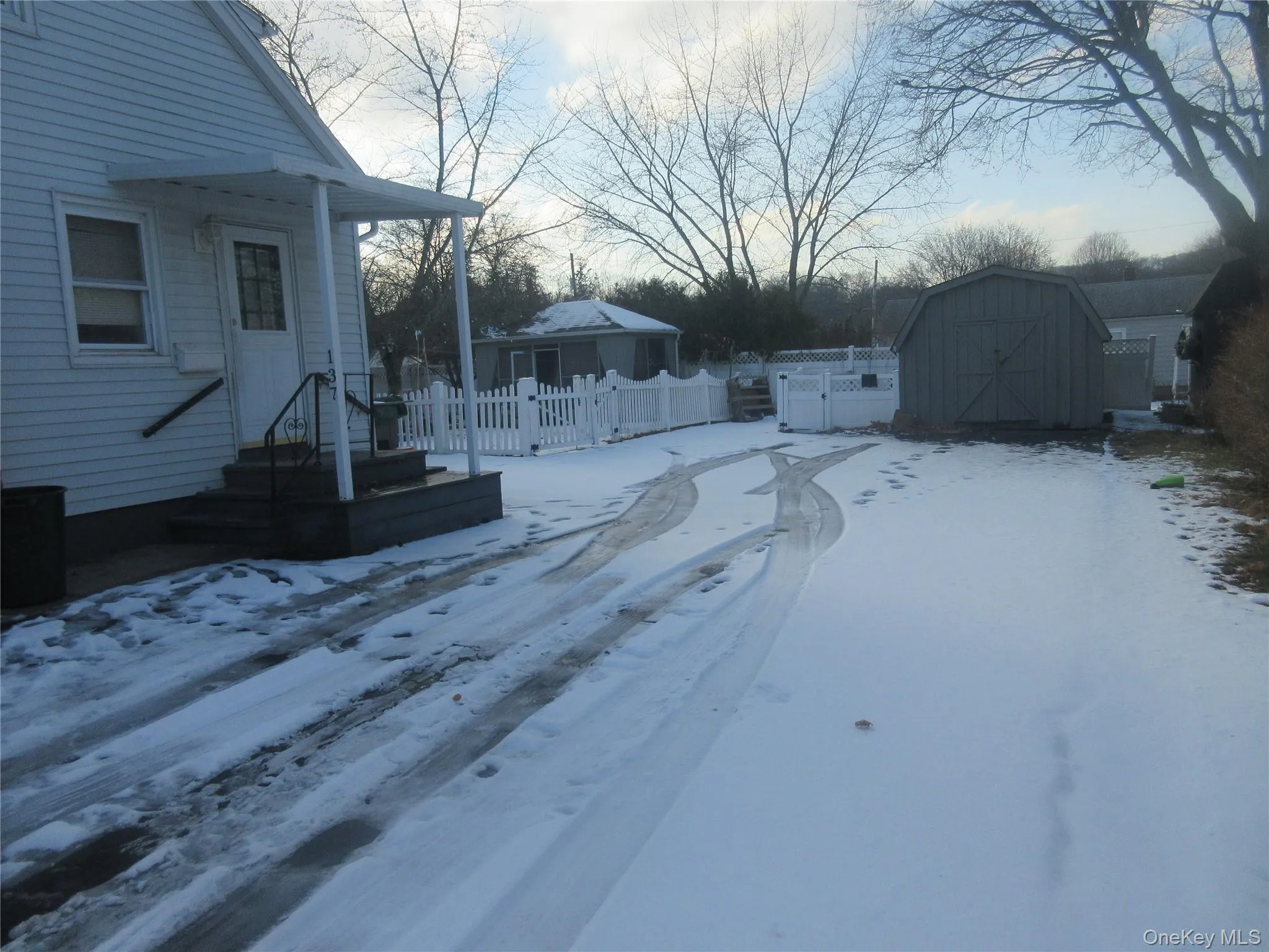 Snowy yard featuring a shed Snowy yard featuring a shed