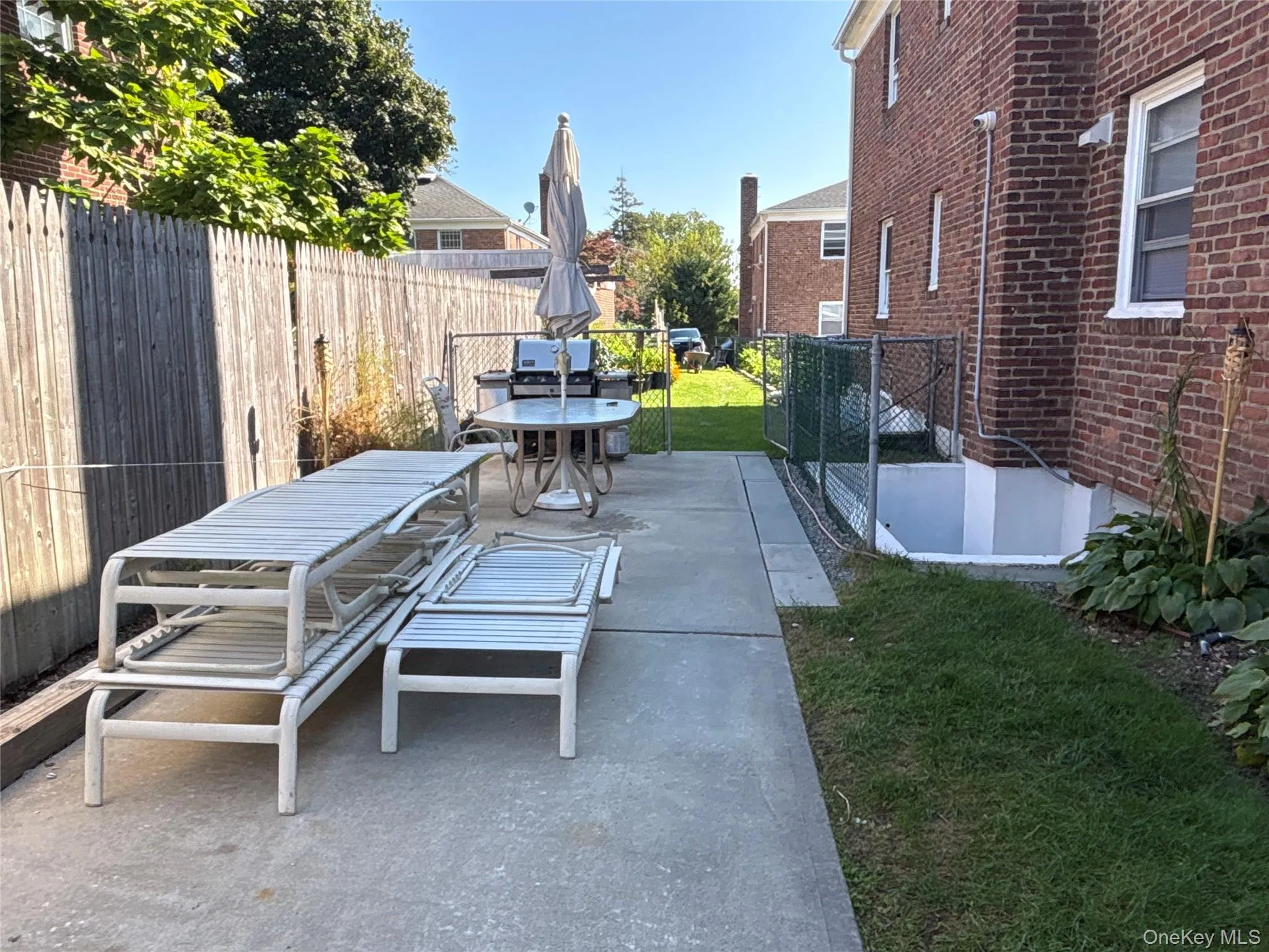 Fenced backyard with outdoor dining area and a patio area Fenced backyard with outdoor dining area and a patio area
