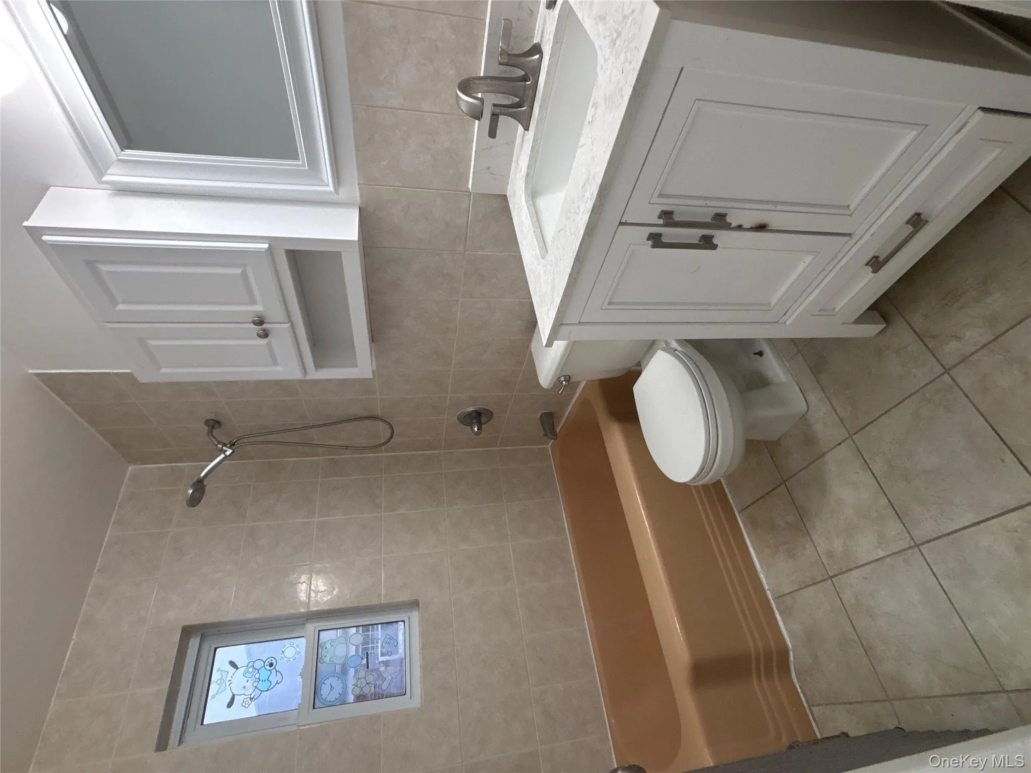 Full bath with vanity, bathtub / shower combination, tile walls, and light tile patterned flooring Full bath with vanity, bathtub / shower combination, tile walls, and light tile patterned flooring