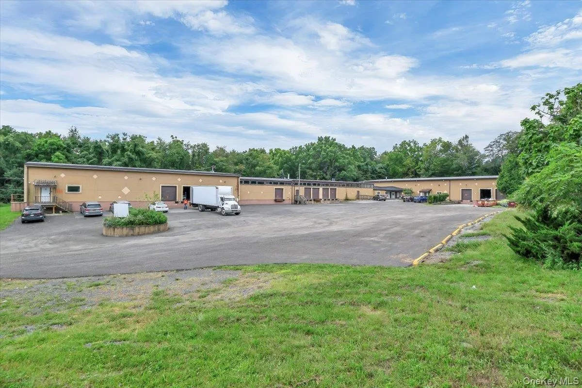 Uncovered parking lot with view of scattered trees Uncovered parking lot with view of scattered trees