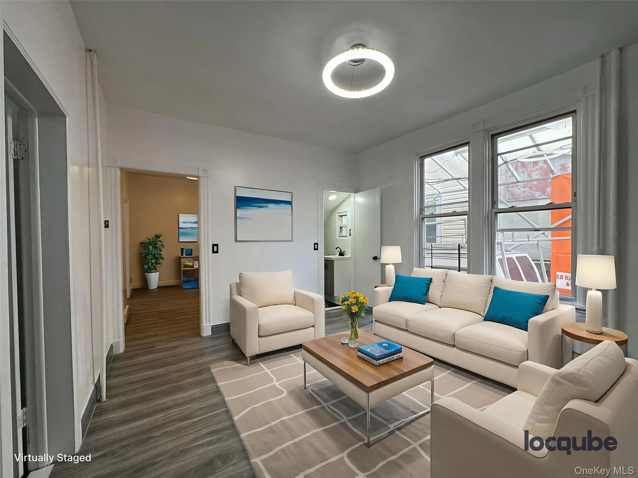 Living area featuring wood finished floors and baseboards Living area featuring wood finished floors and baseboards