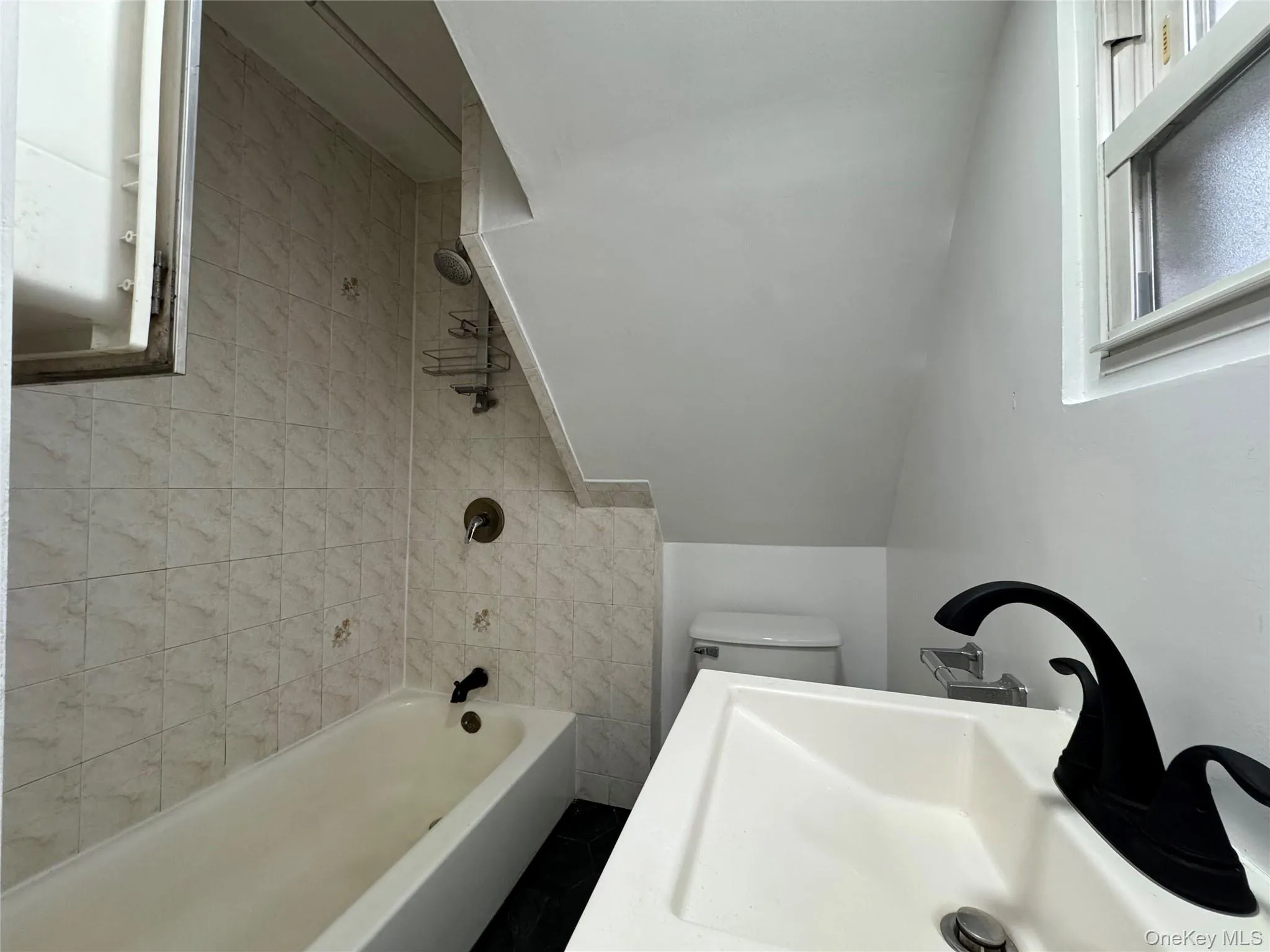 Bathroom with a sink and bathtub / shower combination Bathroom with a sink and bathtub / shower combination