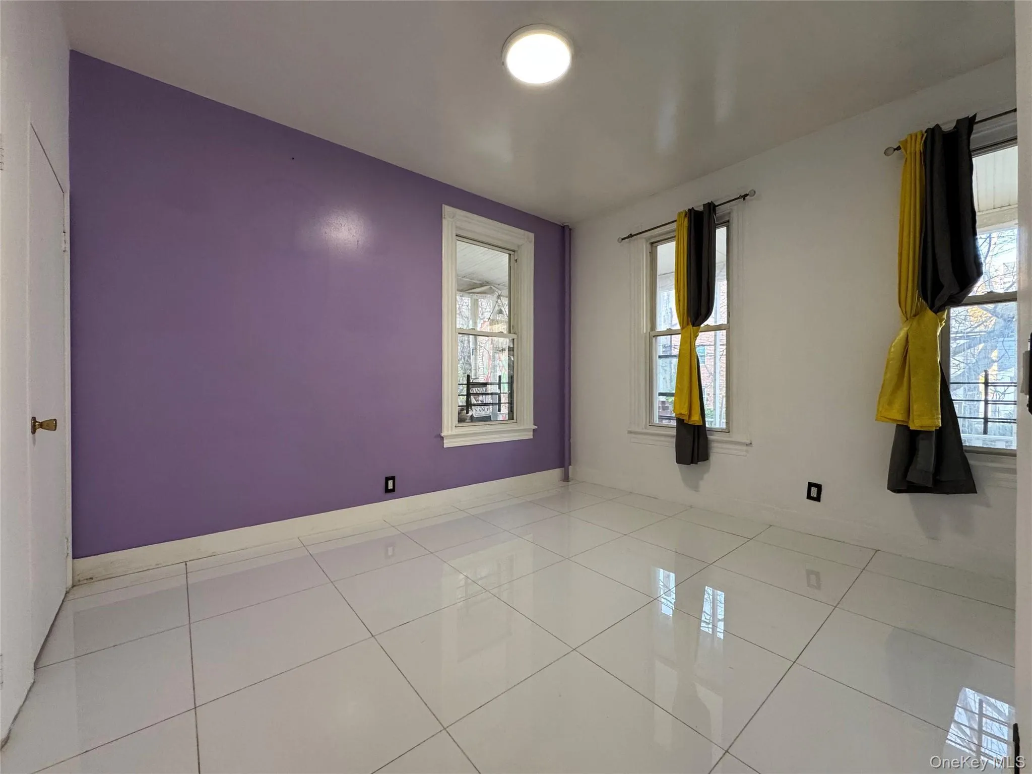 Tiled empty room featuring baseboards Tiled empty room featuring baseboards