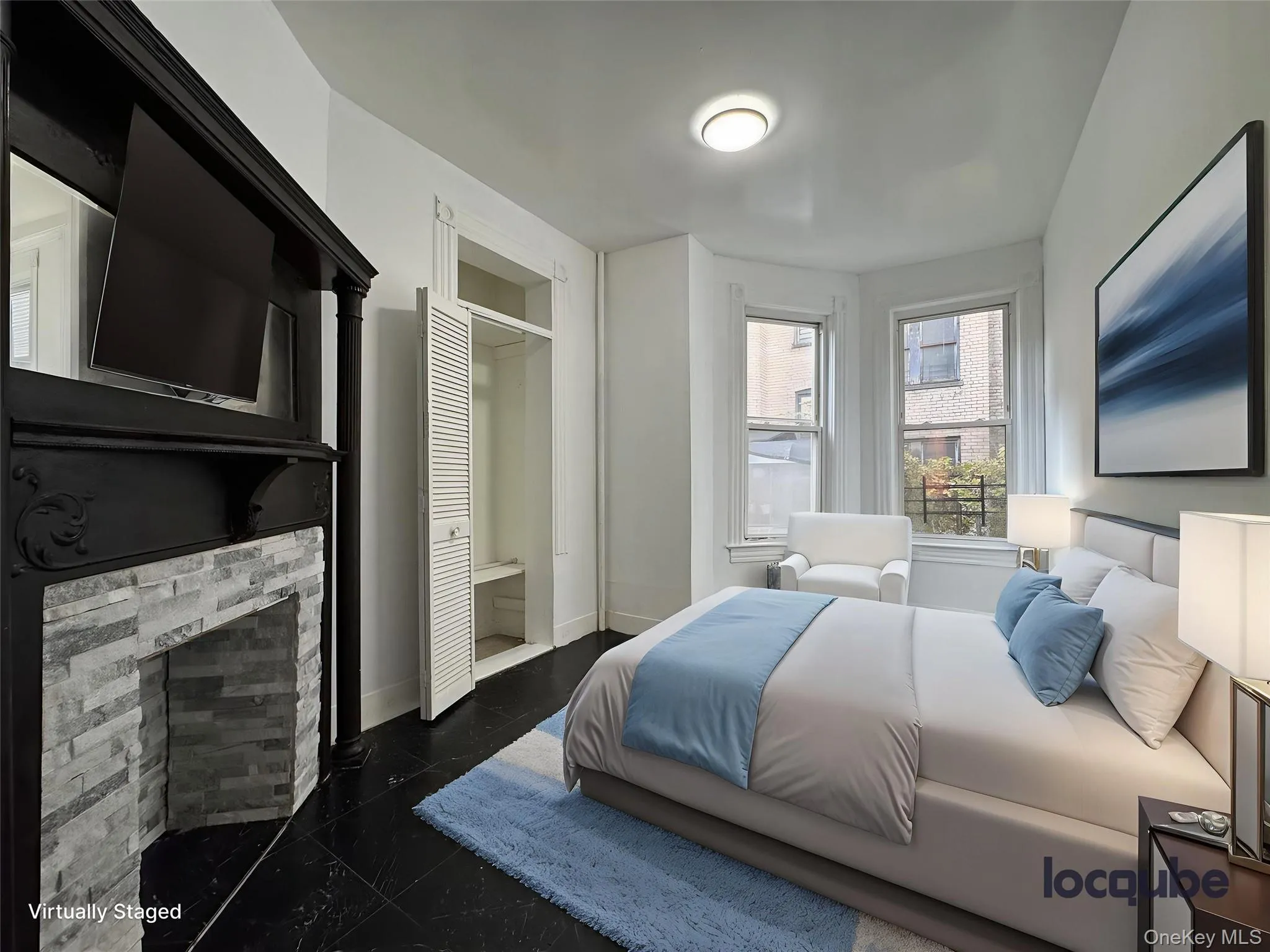 Bedroom featuring a fireplace and granite tiled floors Bedroom featuring a fireplace and granite tiled floors