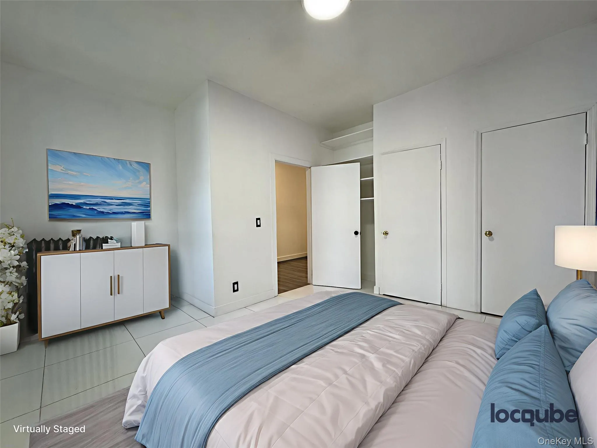 Bedroom featuring light tile patterned floors and two closets Bedroom featuring light tile patterned floors and two closets