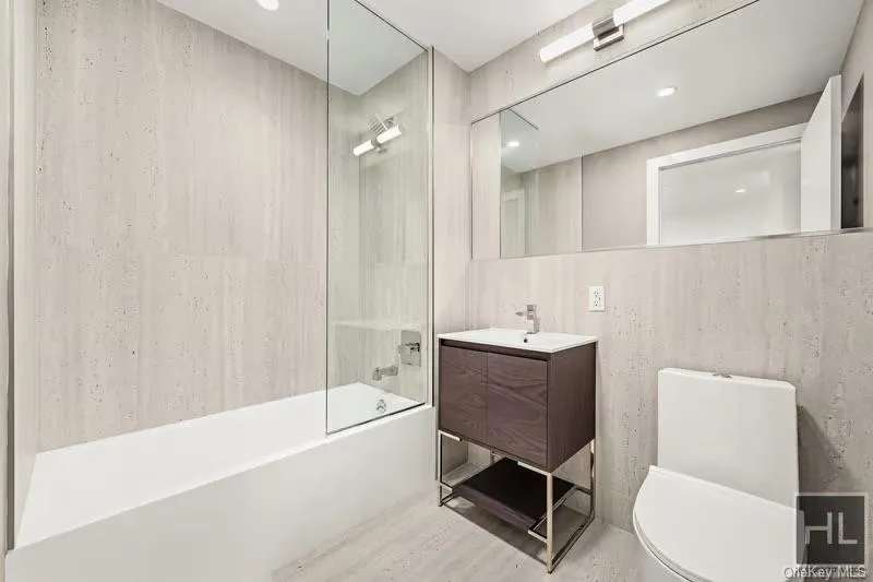 Full bath with shower / bath combo with shower curtain, vanity, wood finished floors, and recessed lighting Full bath with shower / bath combo with shower curtain, vanity, wood finished floors, and recessed lighting