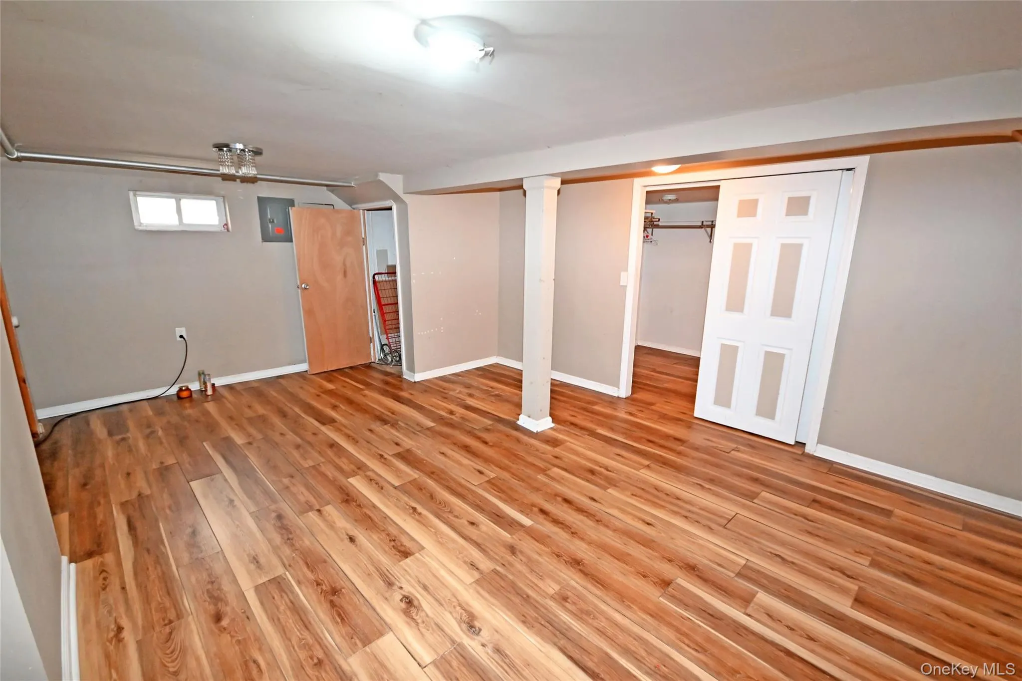 Basement featuring light wood-style floors Basement featuring light wood-style floors