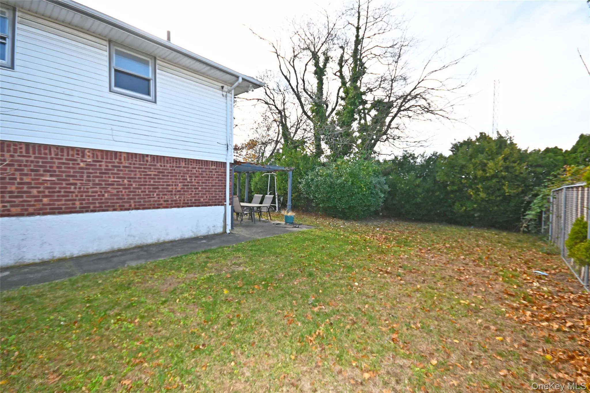 View of yard featuring a patio and a pergola View of yard featuring a patio and a pergola