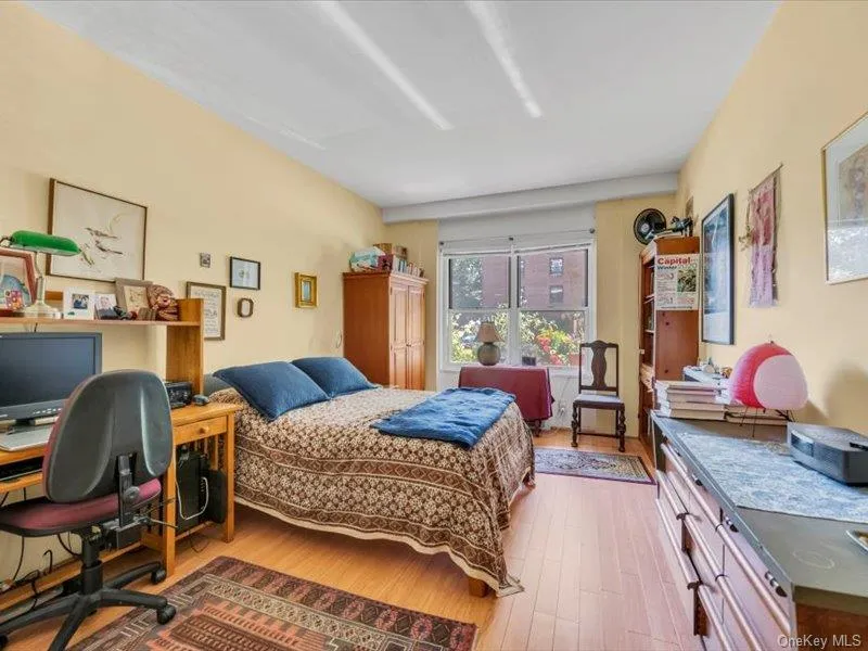 Bedroom with wood finished floors and a desk Bedroom with wood finished floors and a desk