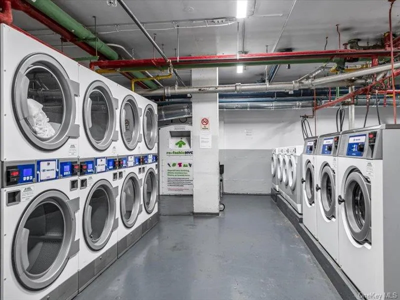 Shared laundry room featuring washing machine and clothes dryer and stacked washer and clothes dryer Shared laundry room featuring washing machine and clothes dryer and stacked washer and clothes dryer