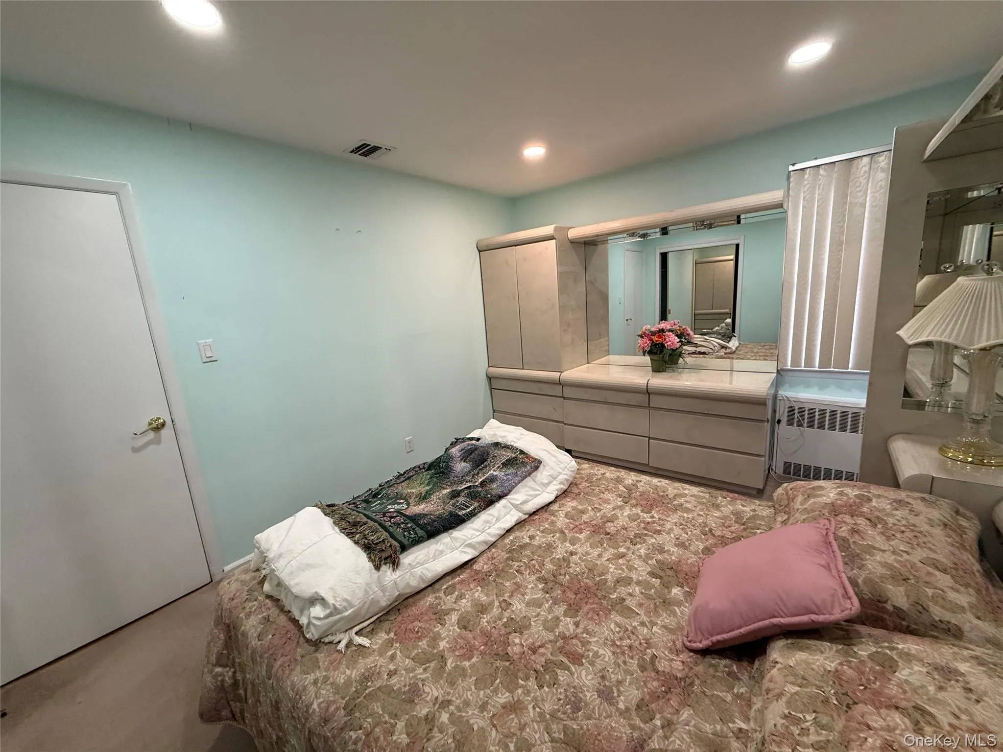 Bedroom featuring radiator, recessed lighting, and carpet floors Bedroom featuring radiator, recessed lighting, and carpet floors