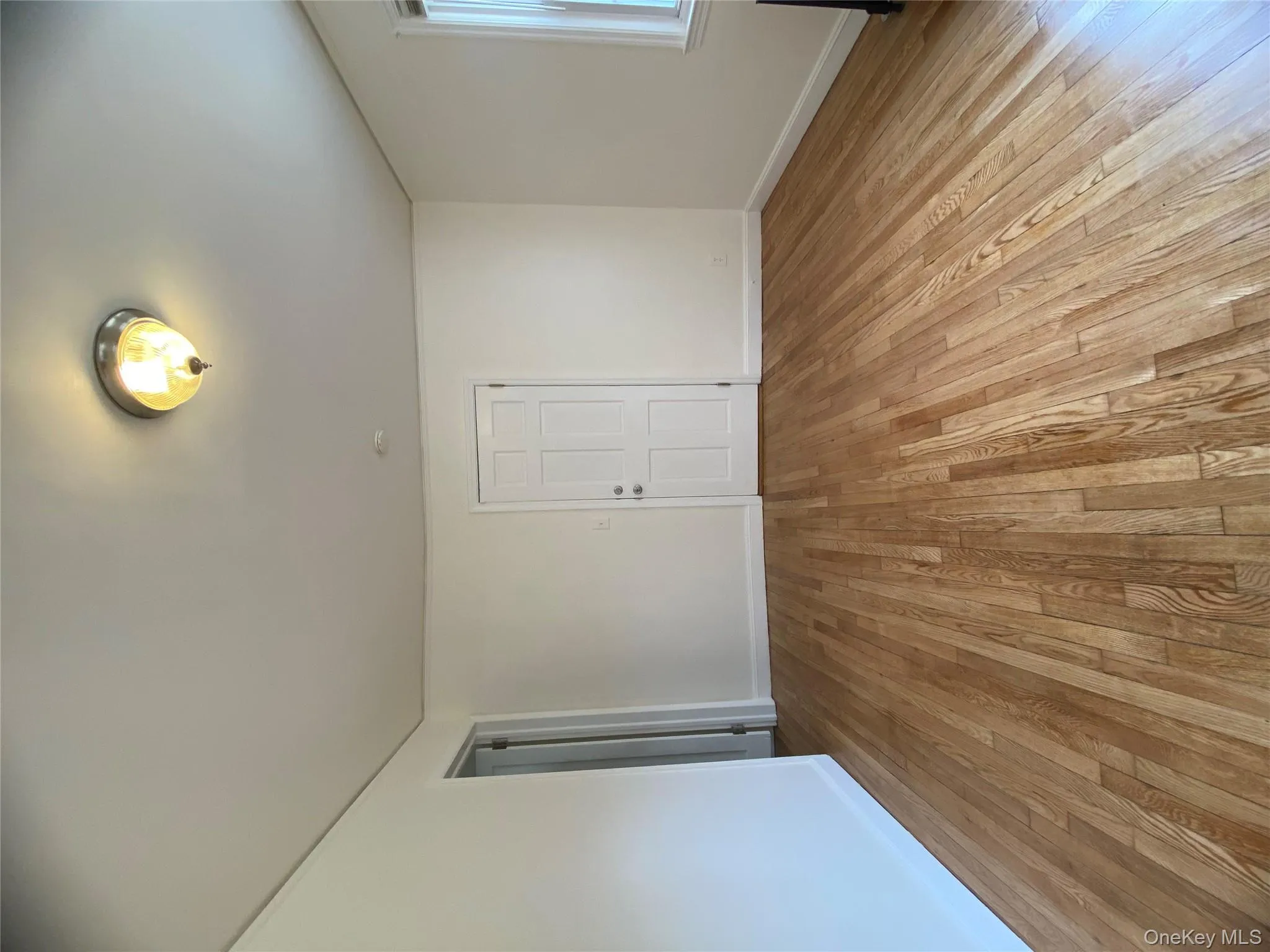 Spare room featuring light wood-style floors and baseboards Spare room featuring light wood-style floors and baseboards
