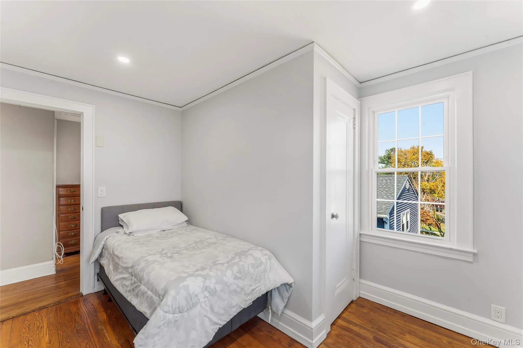 Bedroom featuring dark wood-style flooring, recessed lighting, and ornamental molding Bedroom featuring dark wood-style flooring, recessed lighting, and ornamental molding