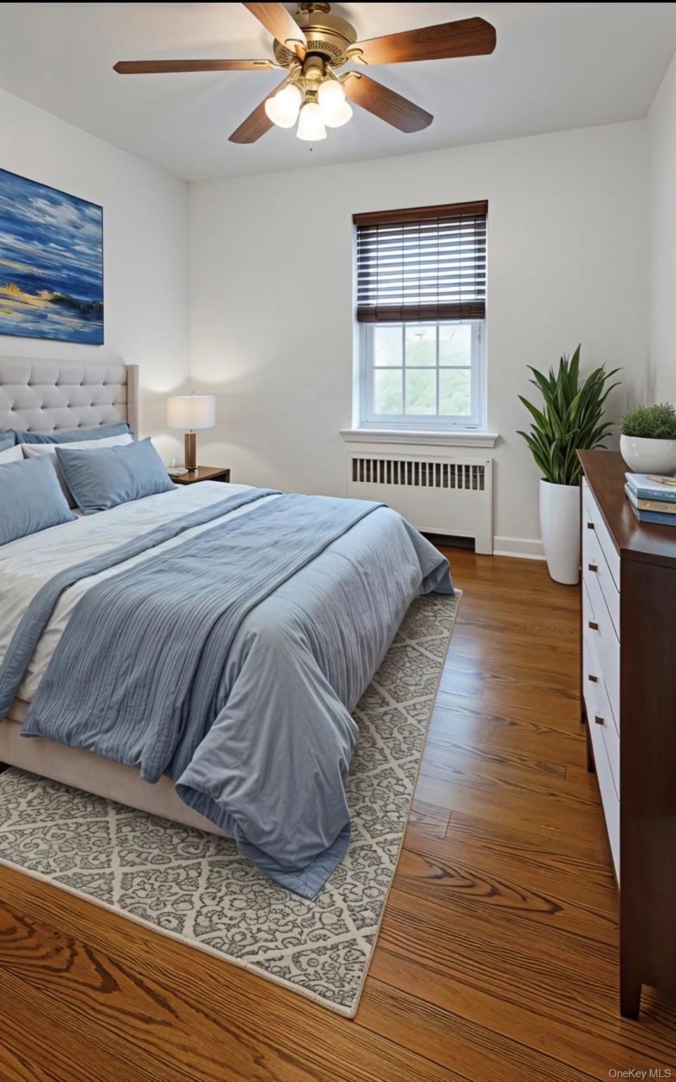 Bedroom featuring radiator heating unit, dark wood finished floors, and ceiling fan Bedroom featuring radiator heating unit, dark wood finished floors, and ceiling fan