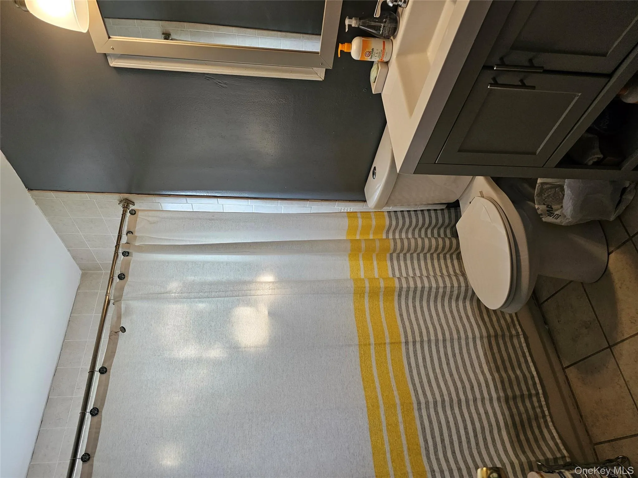 Full bath with vanity, tile patterned flooring, and curtained shower Full bath with vanity, tile patterned flooring, and curtained shower