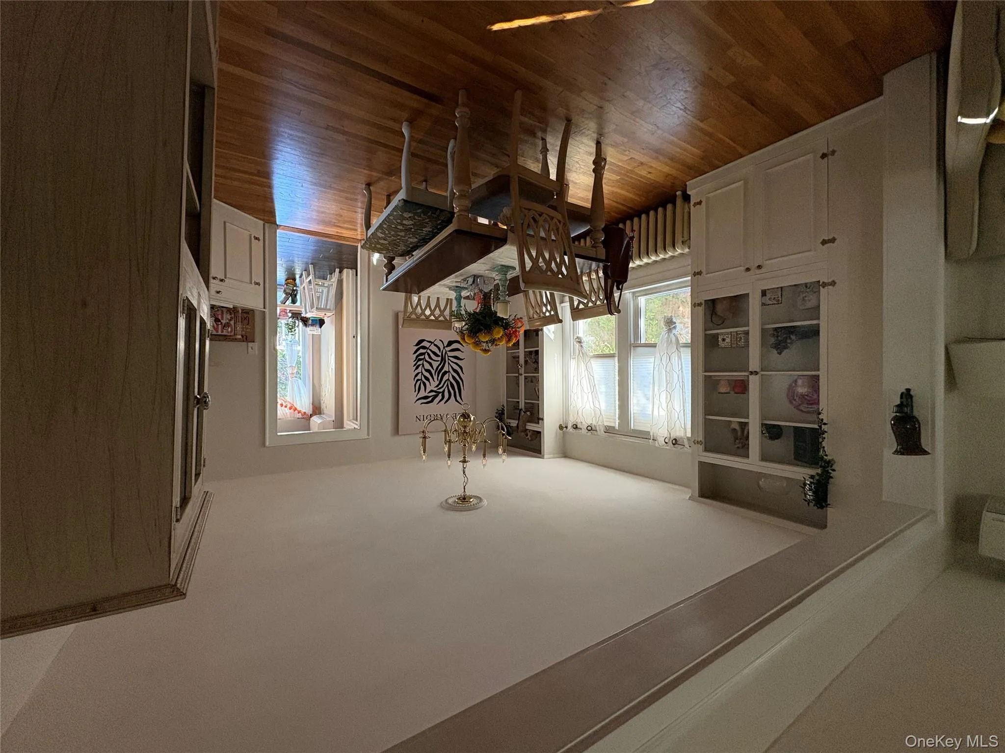 Dining area with a chandelier, dark wood-style flooring, and radiator Dining area with a chandelier, dark wood-style flooring, and radiator