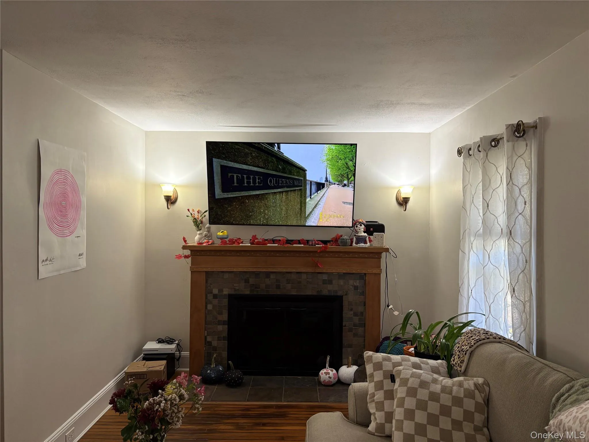Living area featuring a fireplace and wood finished floors Living area featuring a fireplace and wood finished floors