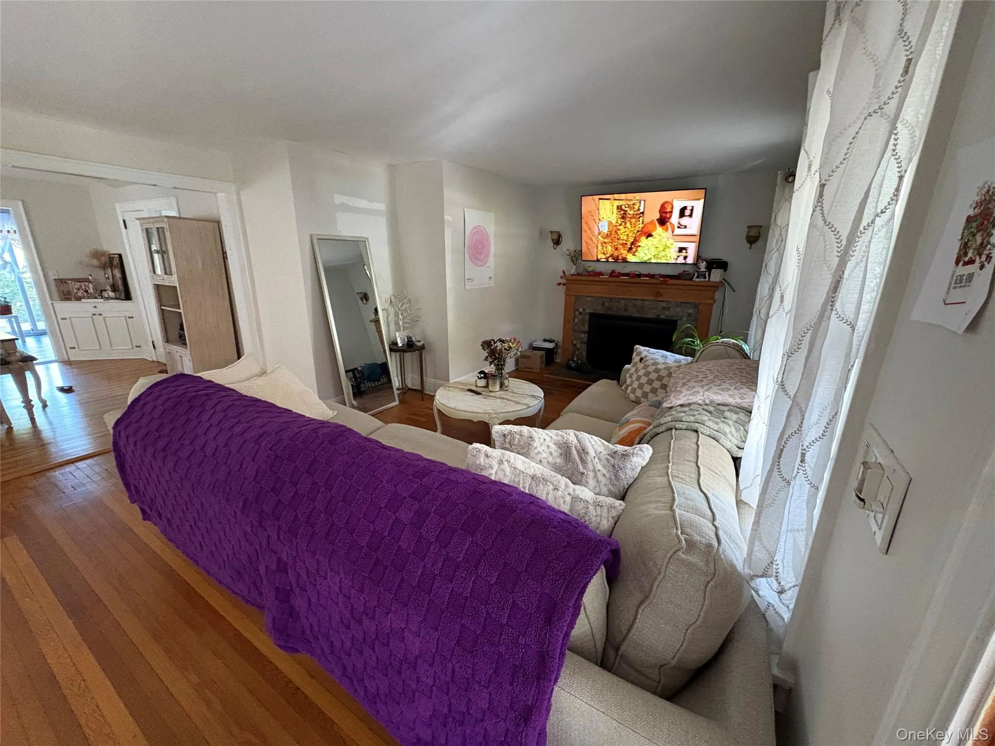 Living area featuring hardwood / wood-style floors and a fireplace Living area featuring hardwood / wood-style floors and a fireplace
