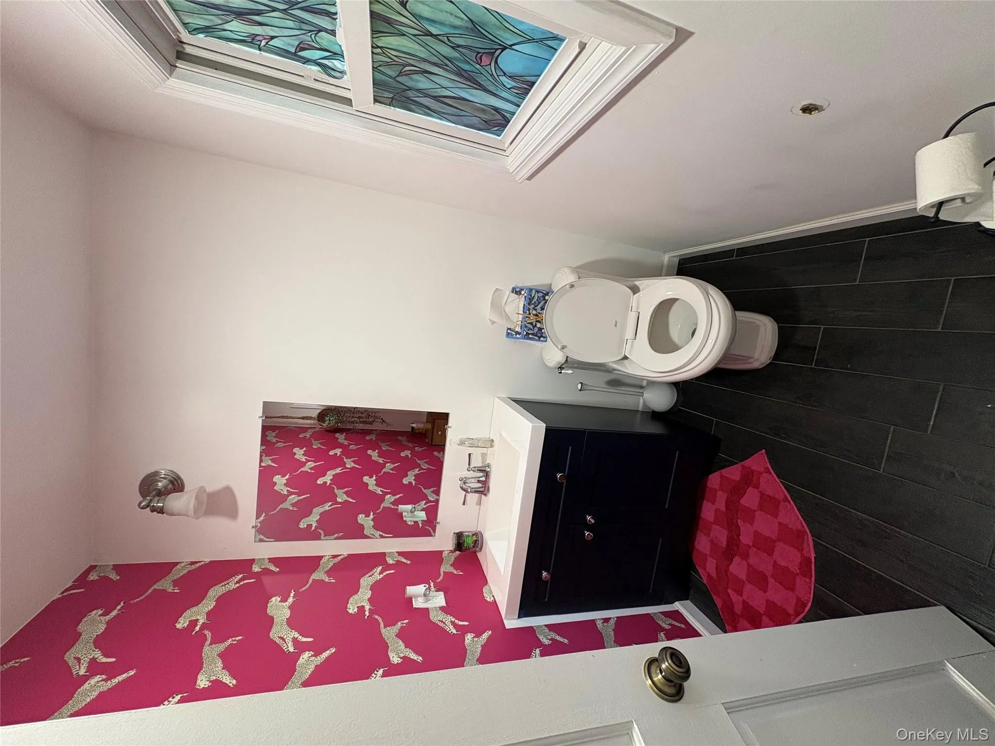 Half bath with dark wood-style flooring and vanity Half bath with dark wood-style flooring and vanity