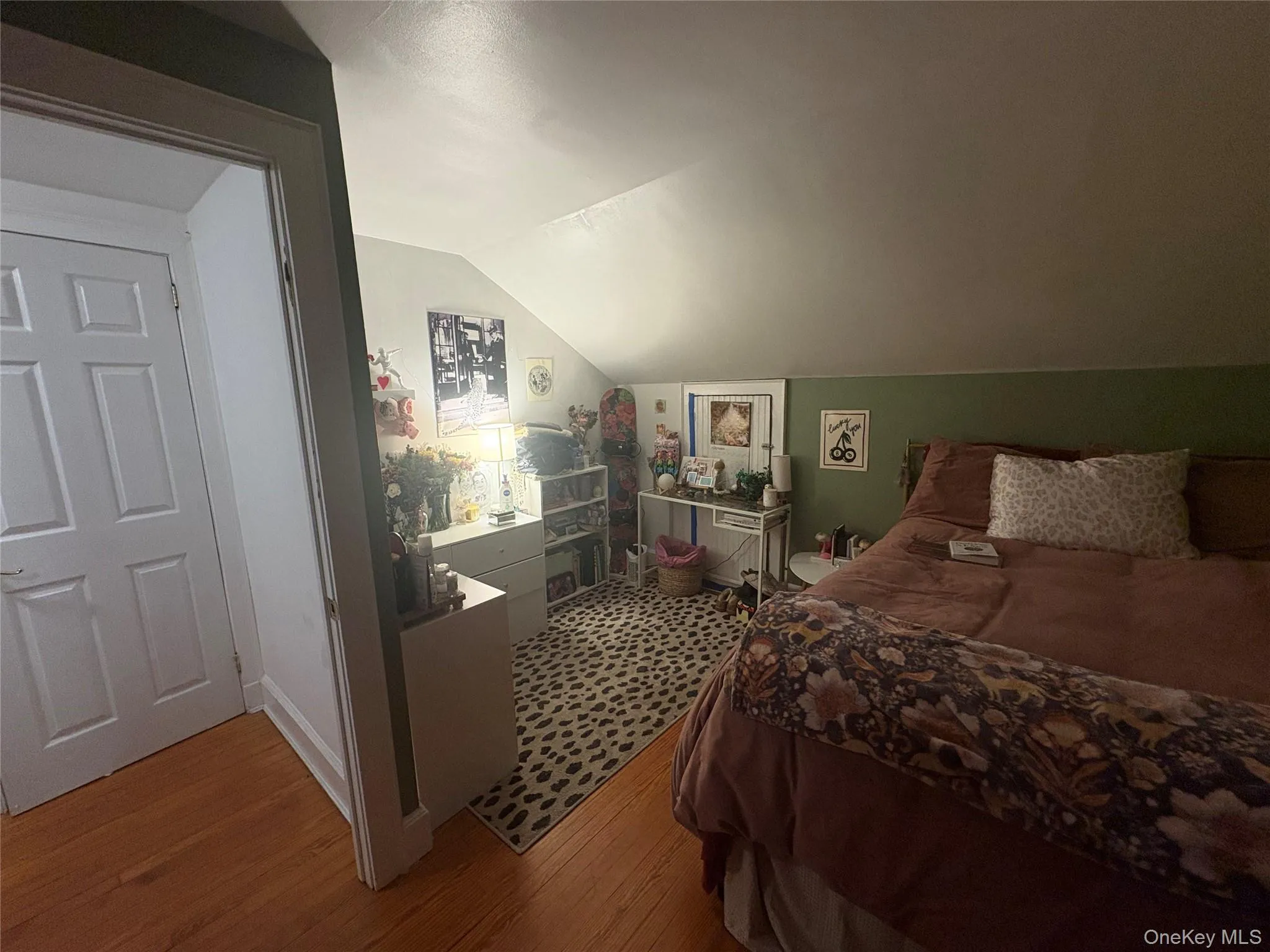 Bedroom with wood finished floors and vaulted ceiling Bedroom with wood finished floors and vaulted ceiling