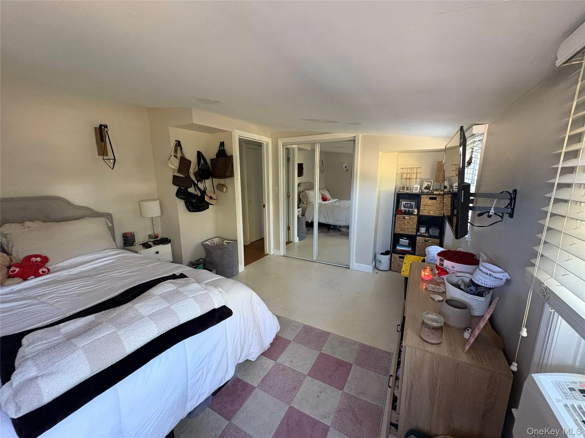 Bedroom featuring a closet,, and a wall unit AC Bedroom featuring a closet,, and a wall unit AC