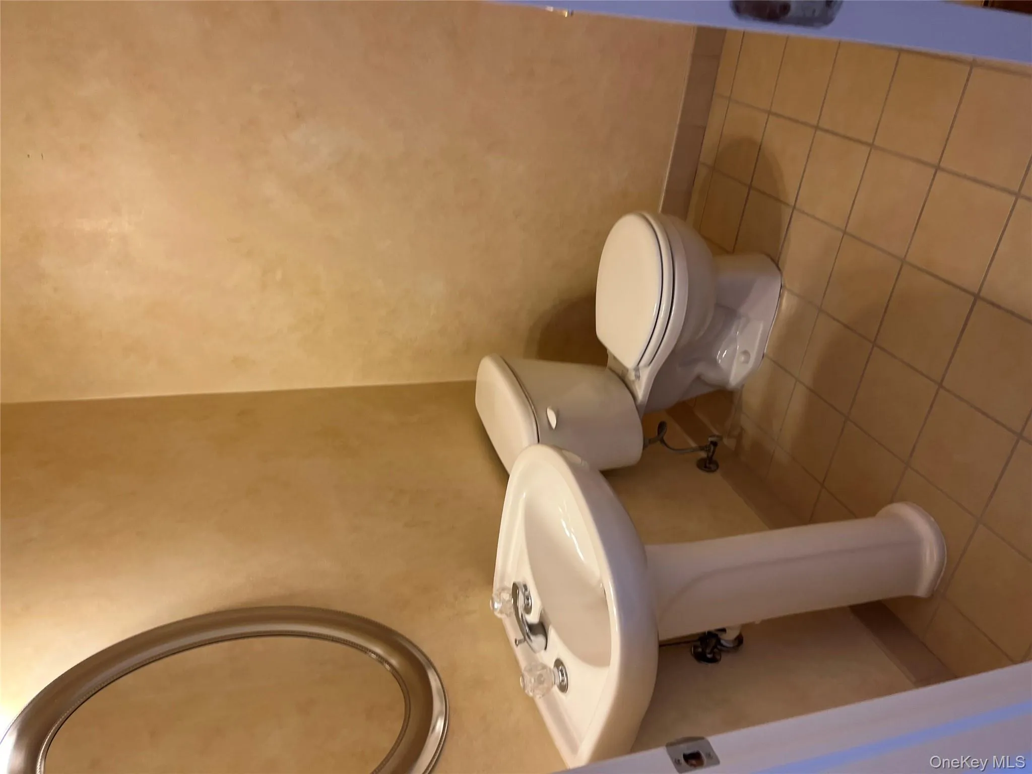 Bathroom with baseboards and light tile patterned floors Bathroom with baseboards and light tile patterned floors