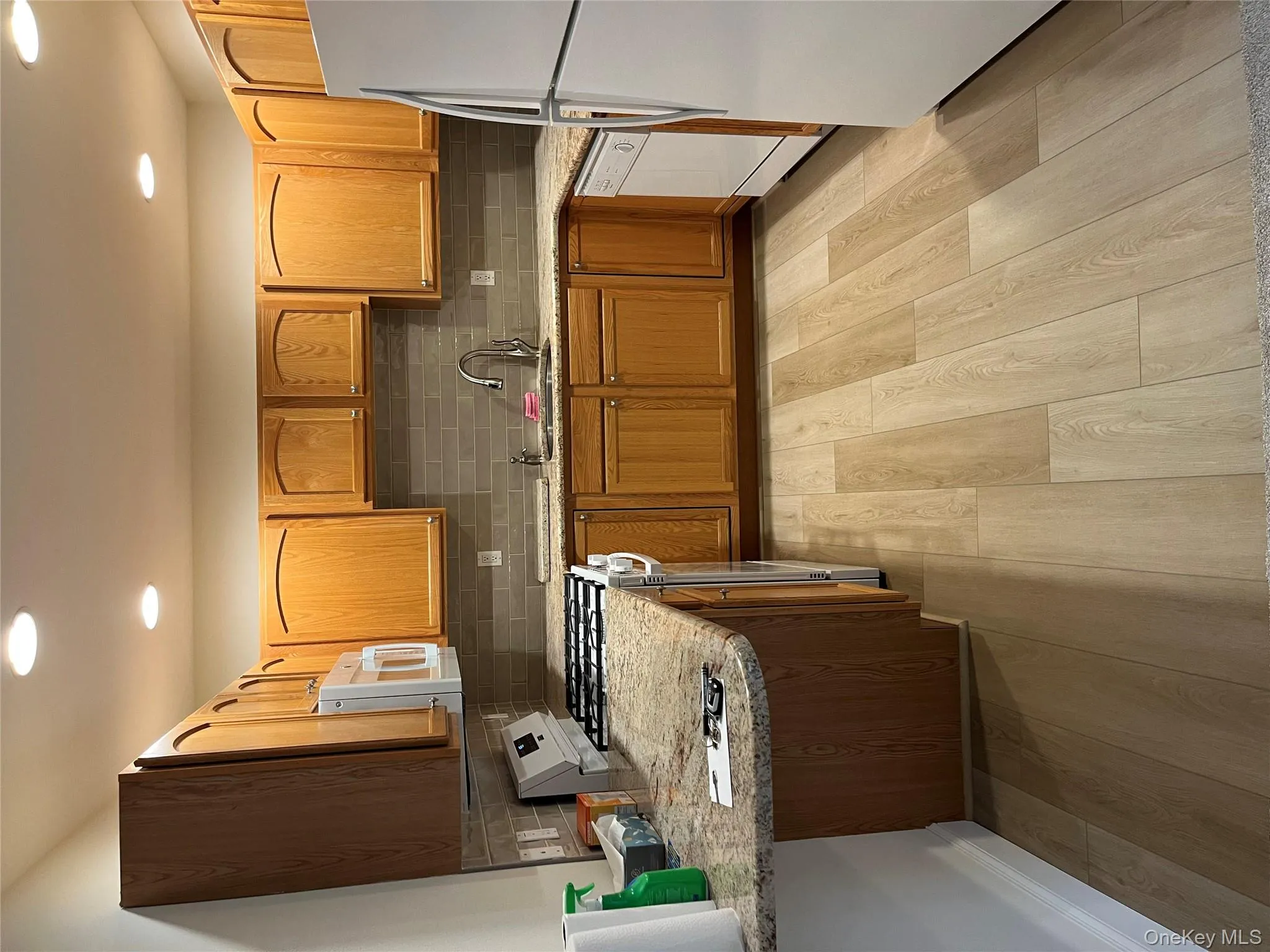 Kitchen featuring decorative backsplash, white stove, fridge, light wood-style floors, and recessed lighting Kitchen featuring decorative backsplash, white stove, fridge, light wood-style floors, and recessed lighting