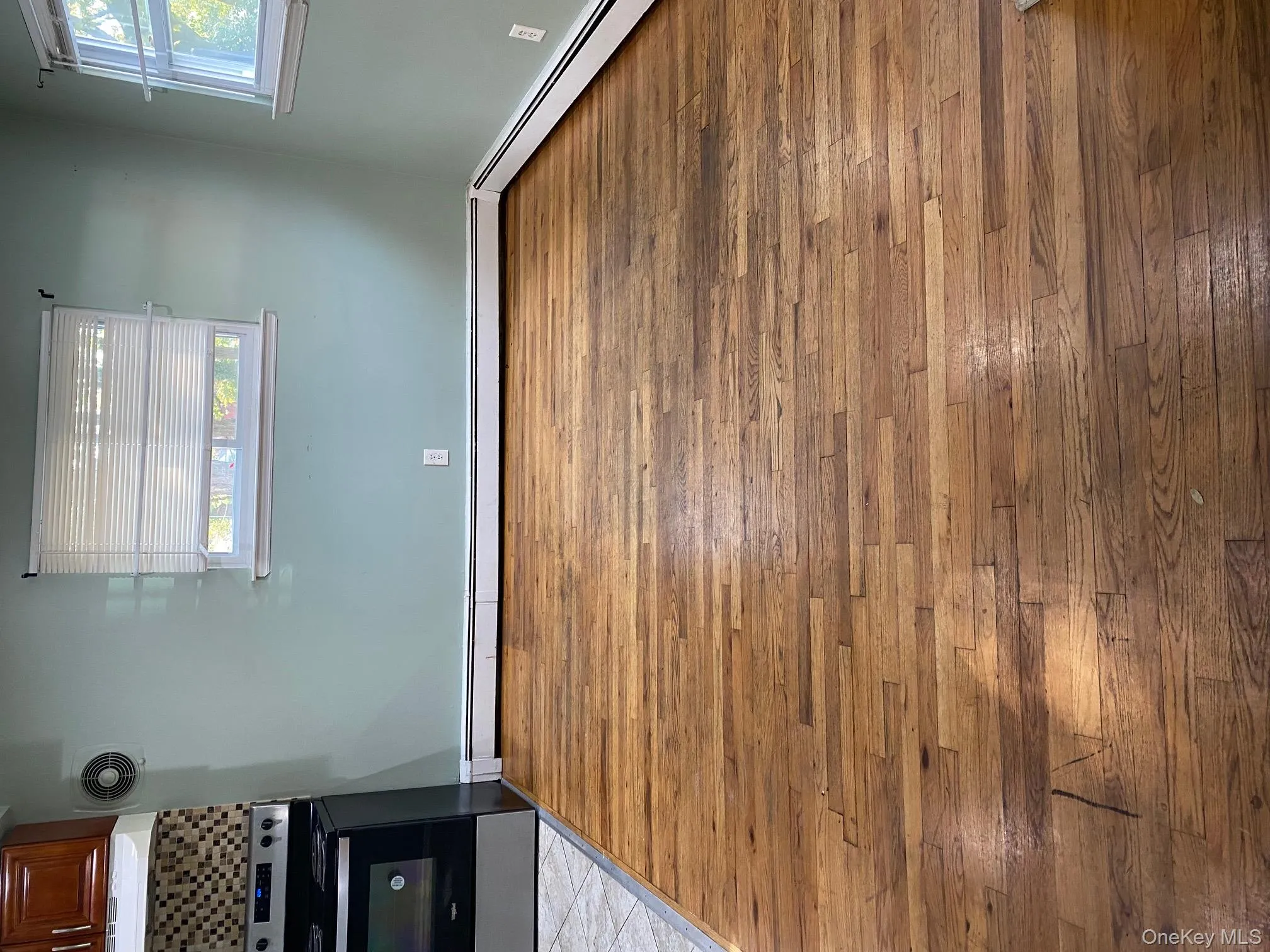 Unfurnished dining area with baseboard heating and dark wood finished floors Unfurnished dining area with baseboard heating and dark wood finished floors