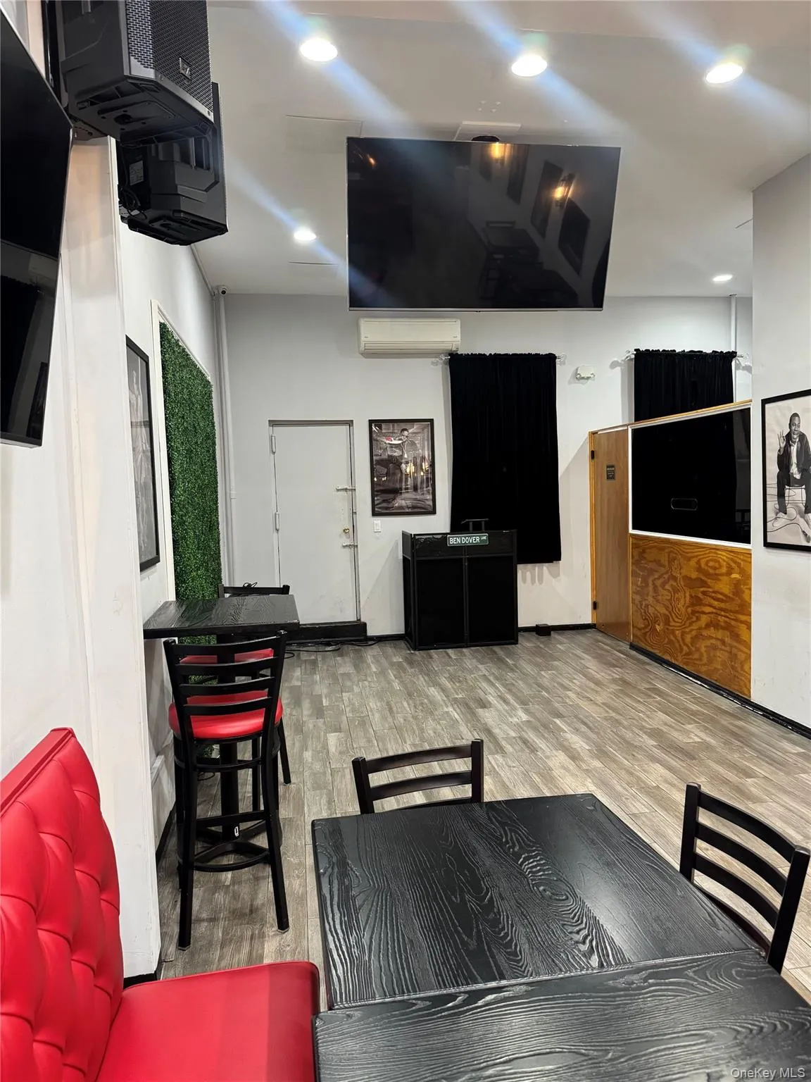 Dining room featuring wood finished floors, recessed lighting, and a wall mounted AC Dining room featuring wood finished floors, recessed lighting, and a wall mounted AC