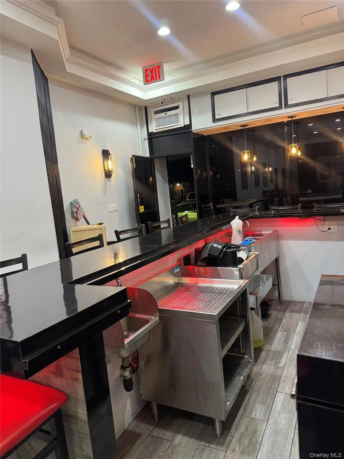 Bar featuring ornamental molding, recessed lighting, and stainless steel counters Bar featuring ornamental molding, recessed lighting, and stainless steel counters