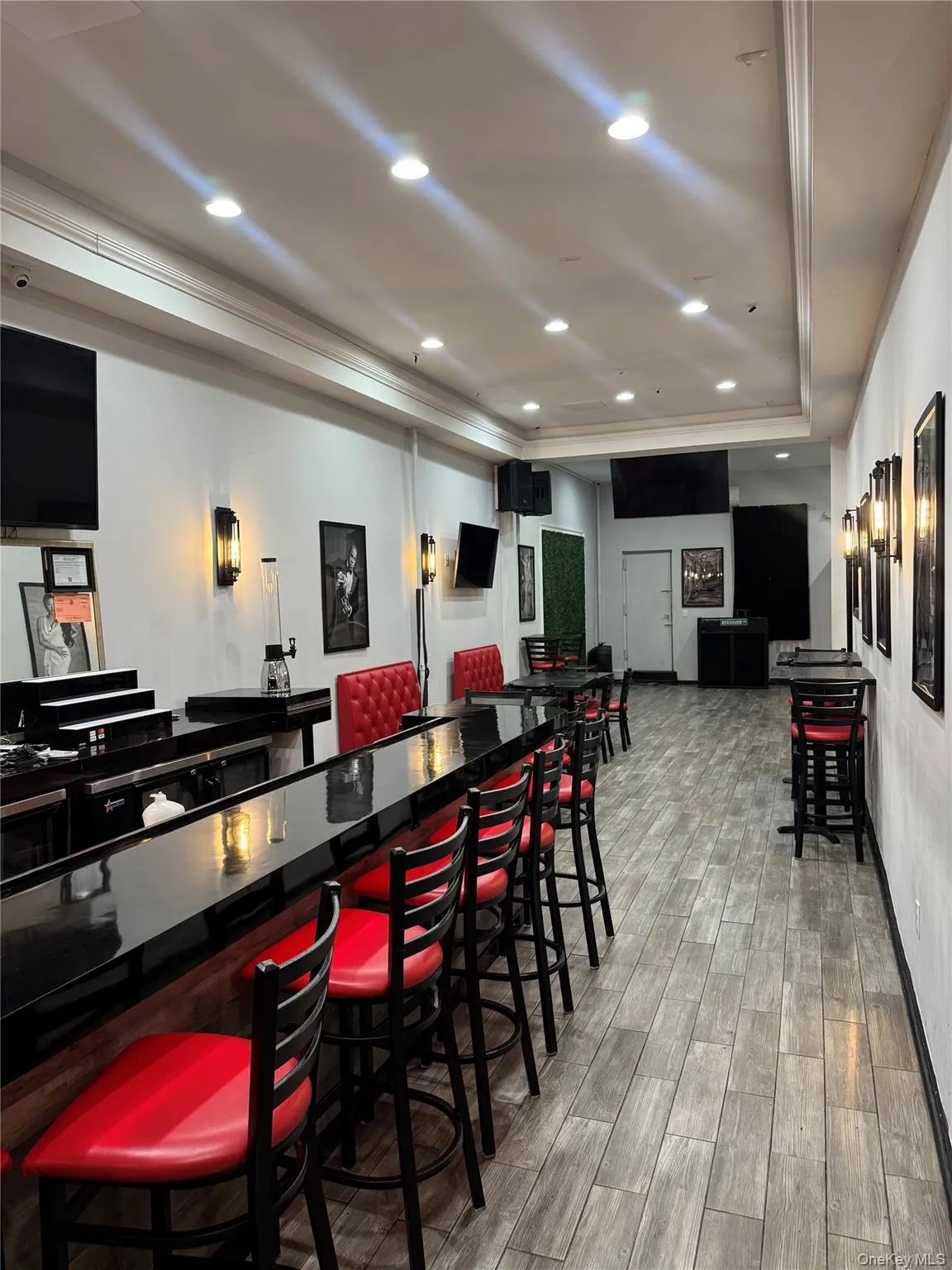 Community bar area with recessed lighting, ornamental molding, and dark countertops Community bar area with recessed lighting, ornamental molding, and dark countertops