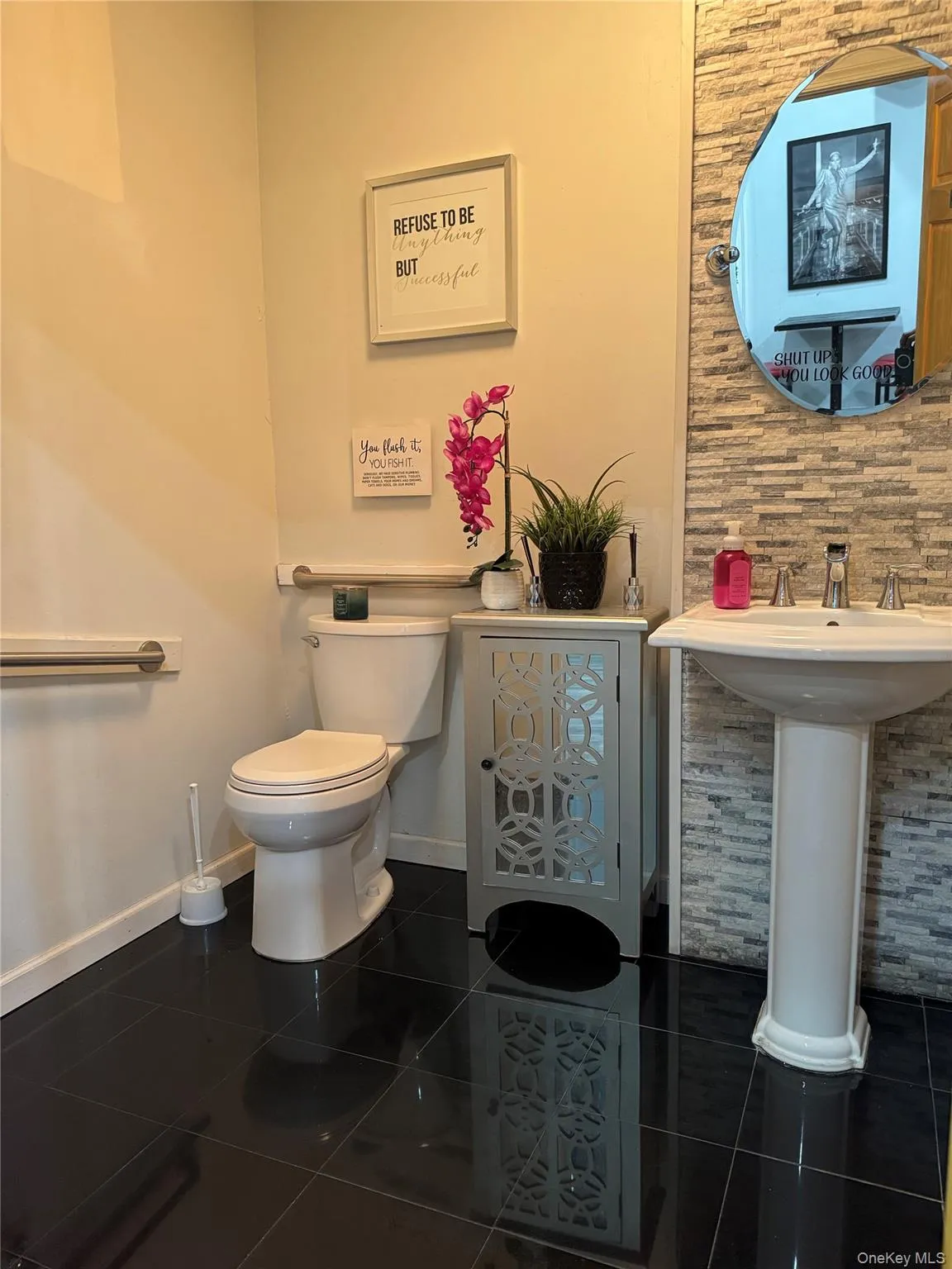 Half bath featuring dark tile patterned flooring Half bath featuring dark tile patterned flooring