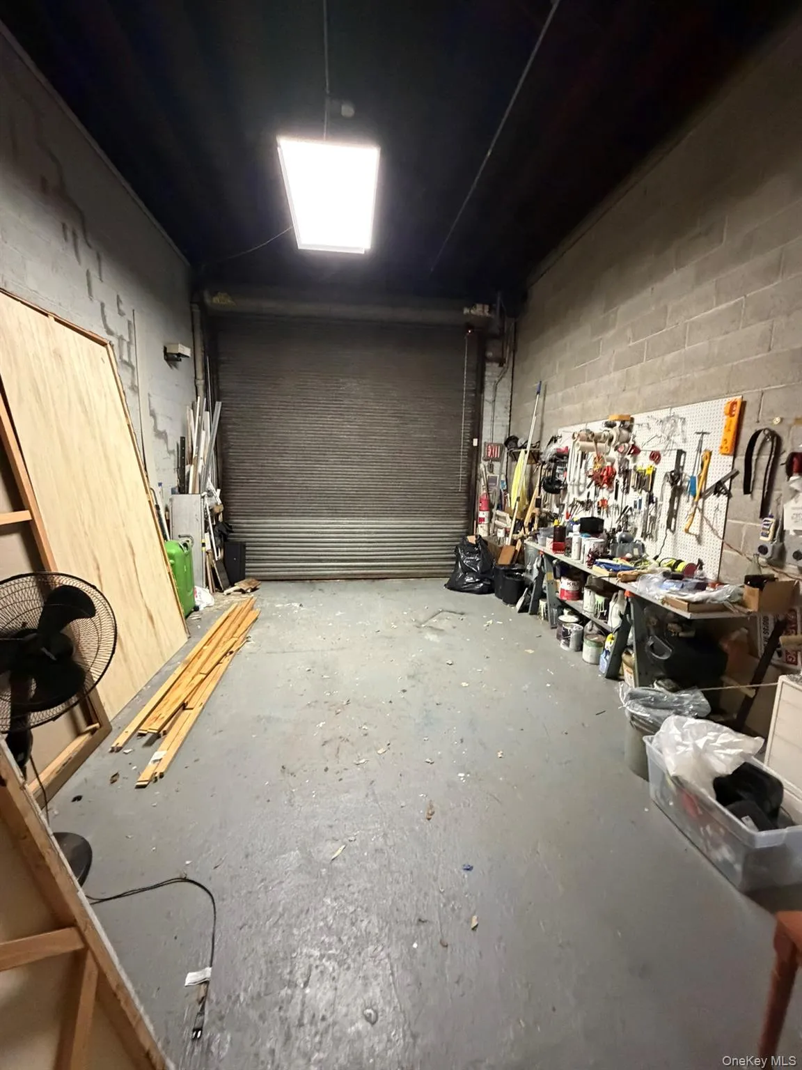 Garage with a workshop area and concrete block wall Garage with a workshop area and concrete block wall