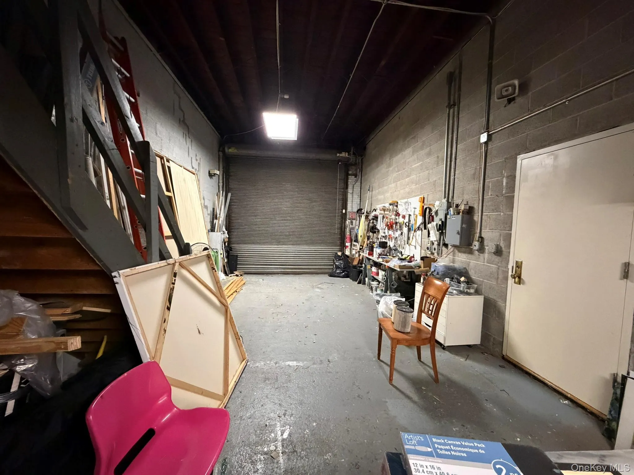 Garage with a workshop area and concrete block wall Garage with a workshop area and concrete block wall