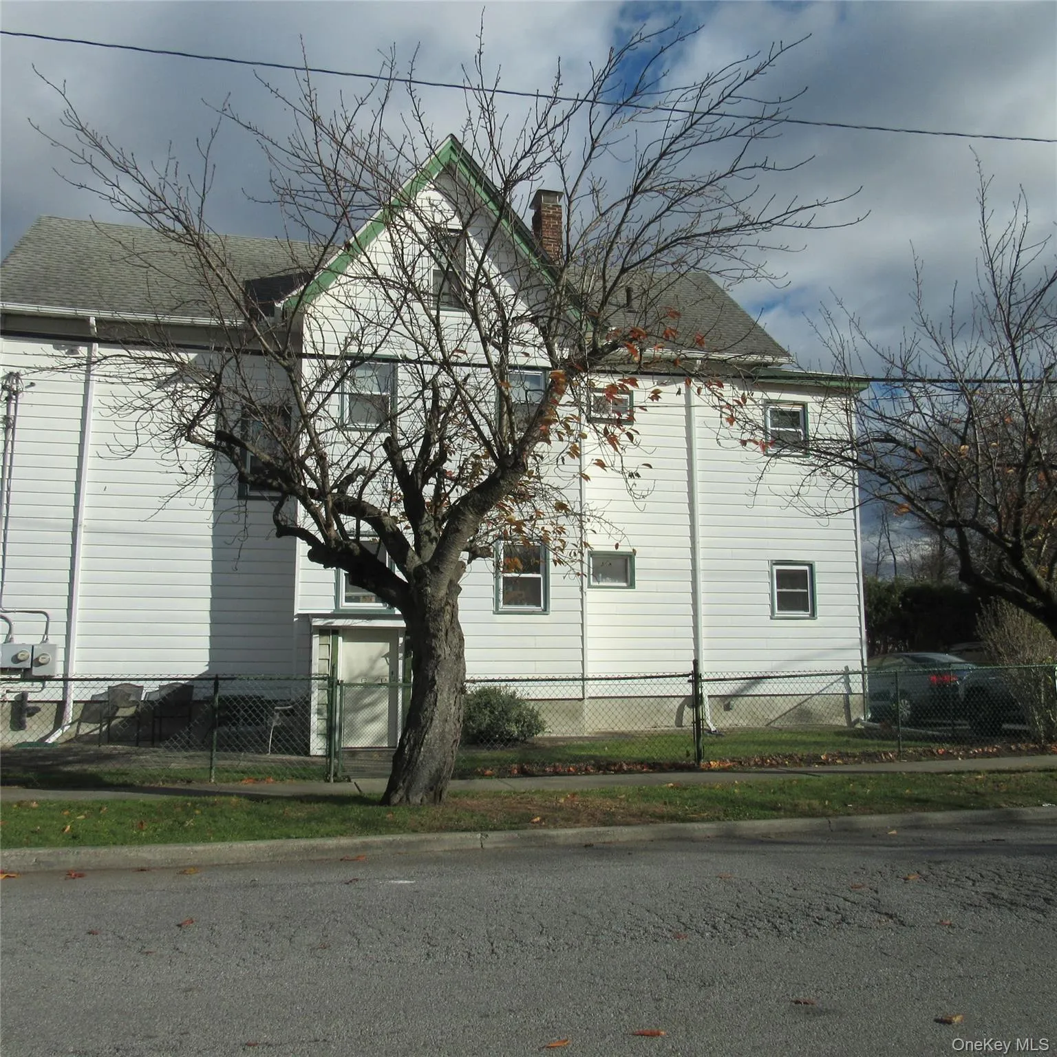View of side of property with a fenced front yard and a chimney View of side of property with a fenced front yard and a chimney