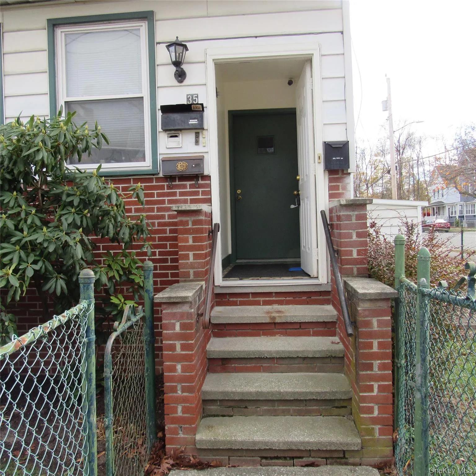 Property entrance featuring brick siding and a gate Property entrance featuring brick siding and a gate