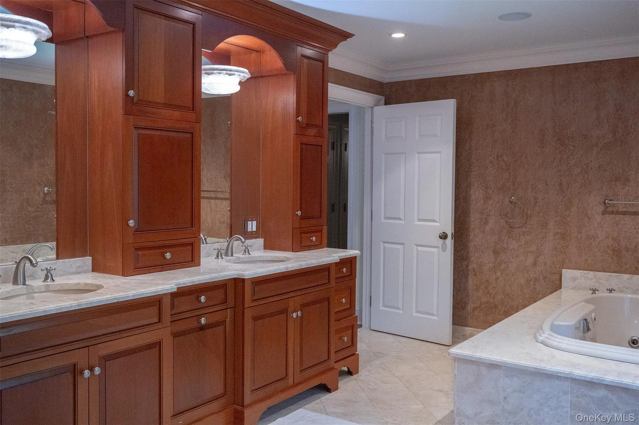 Soaking tub with custom cabinetry and steam shower with generous proportions . Soaking tub with custom cabinetry and steam shower with generous proportions .
