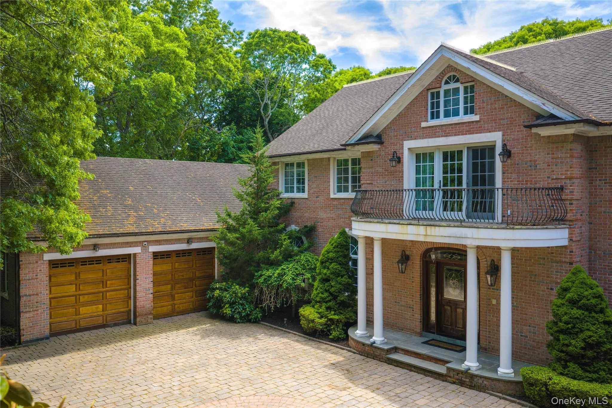 Front courtyard entrance with brick construction and copper gutter details with attached 2 car garage. Front courtyard entrance with brick construction and copper gutter details with attached 2 car garage.