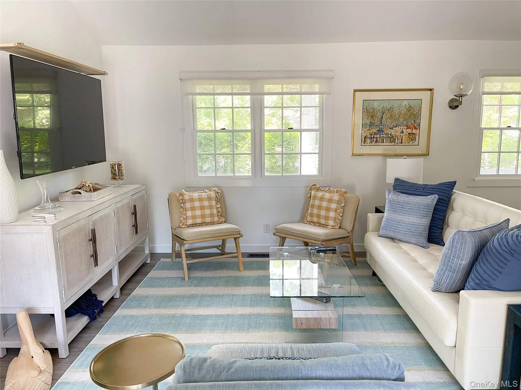 Living room featuring wood-type flooring and vaulted ceiling Living room featuring wood-type flooring and vaulted ceiling