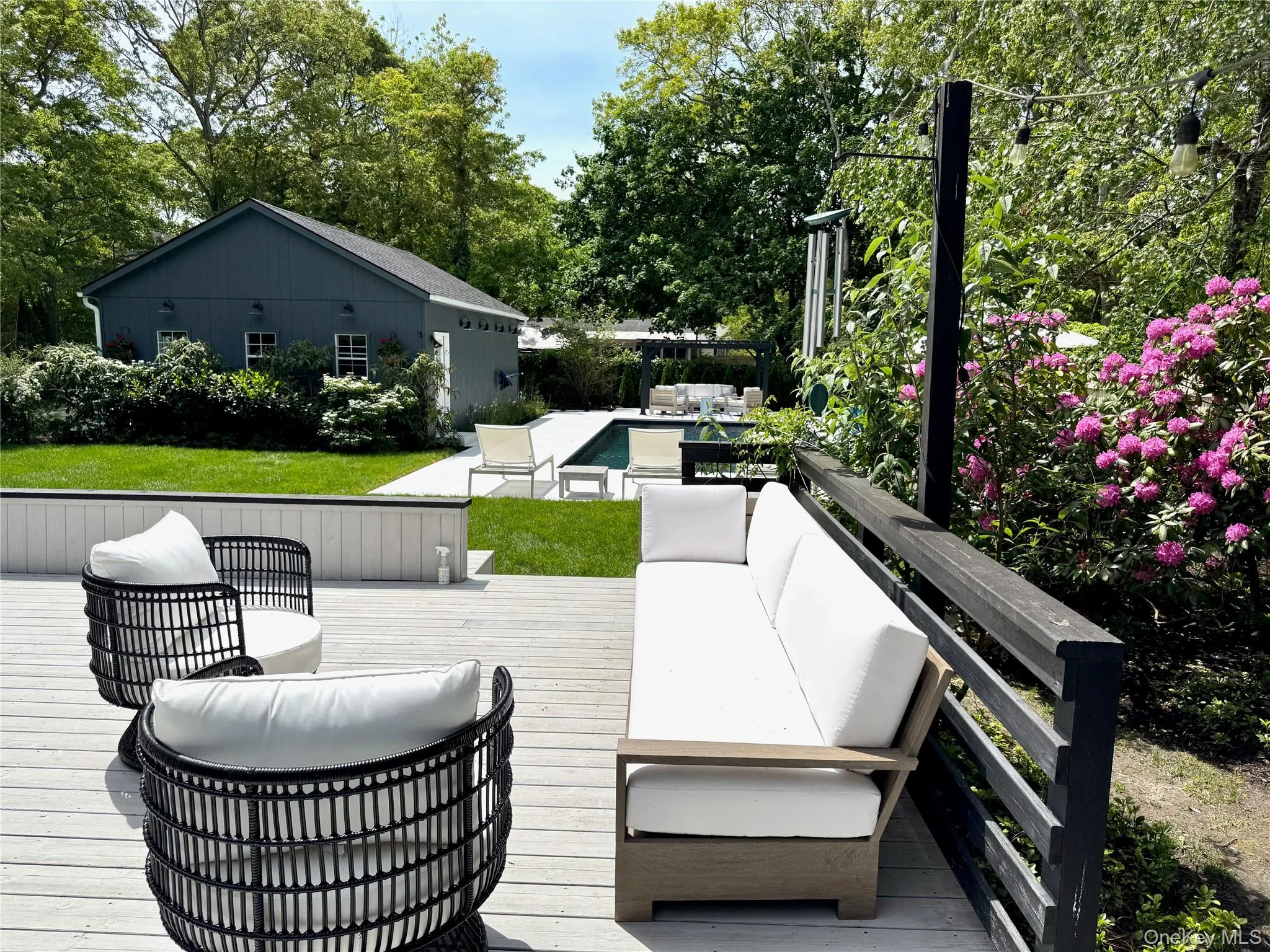 Wooden terrace featuring an outdoor living space and a lawn Wooden terrace featuring an outdoor living space and a lawn