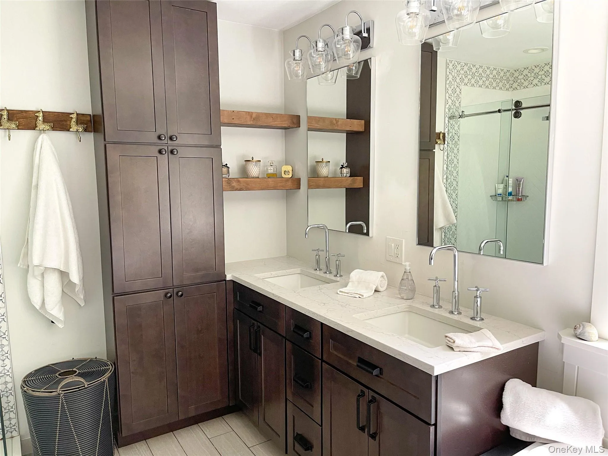 Bathroom featuring vanity and a shower with shower door Bathroom featuring vanity and a shower with shower door