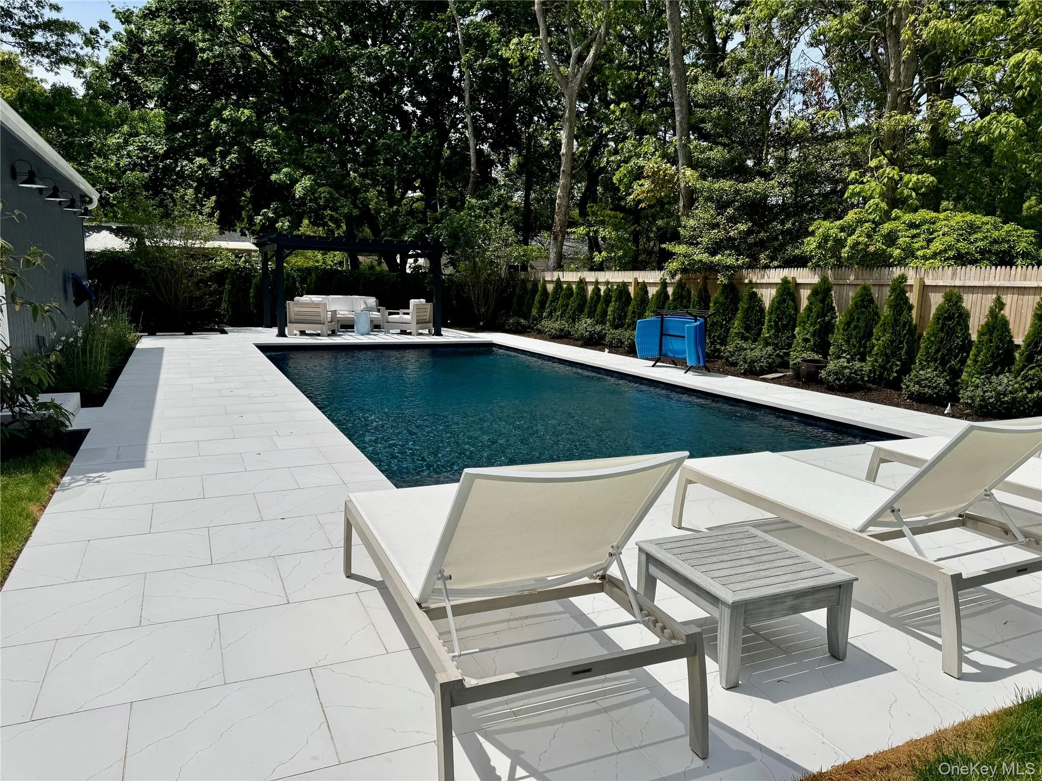 View of pool featuring a patio area, a fenced backyard, and outdoor lounge area View of pool featuring a patio area, a fenced backyard, and outdoor lounge area