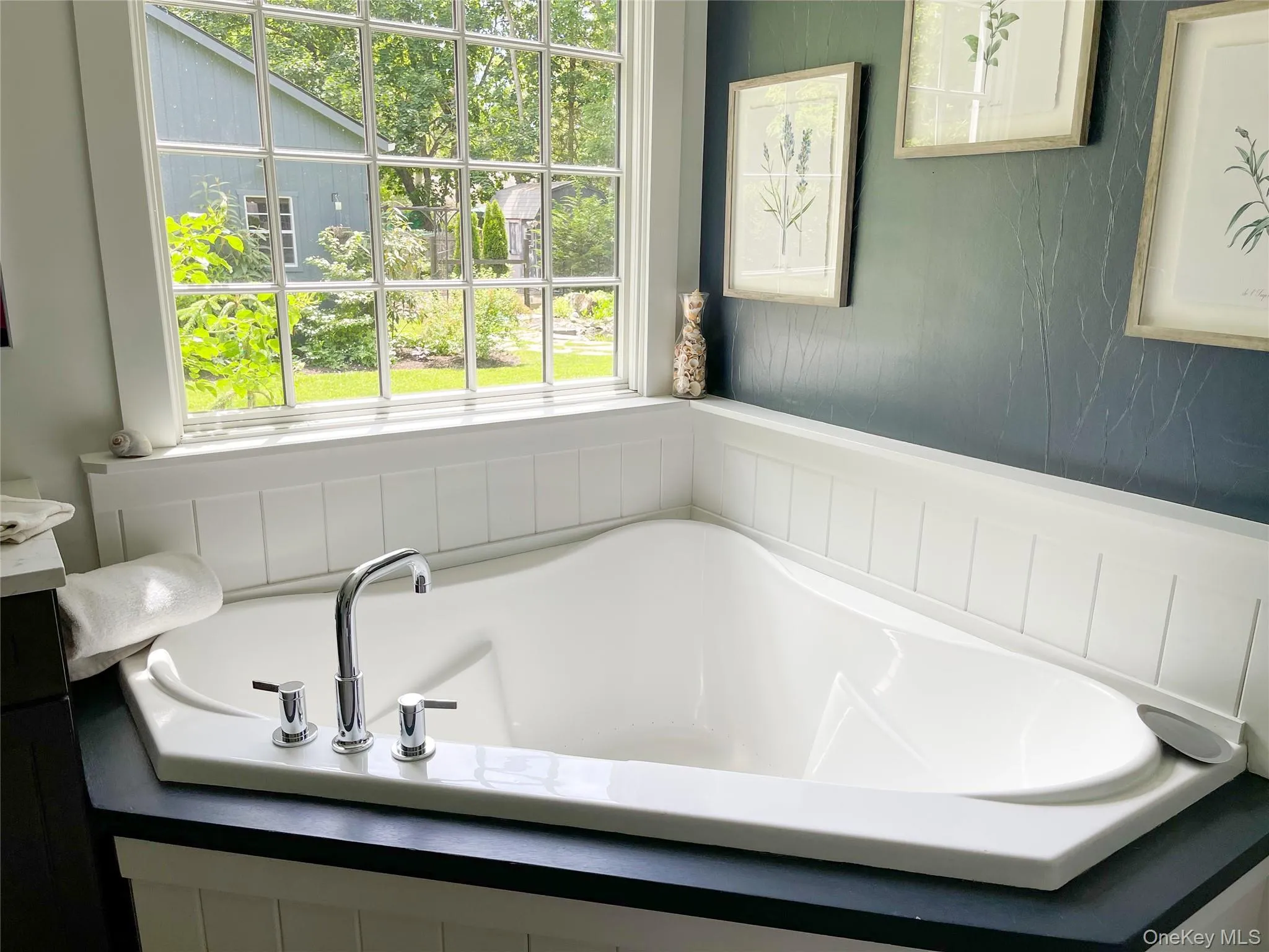 Bathroom with a tub and plenty of natural light Bathroom with a tub and plenty of natural light