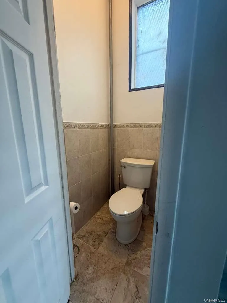 Bathroom with tile walls and wainscoting Bathroom with tile walls and wainscoting