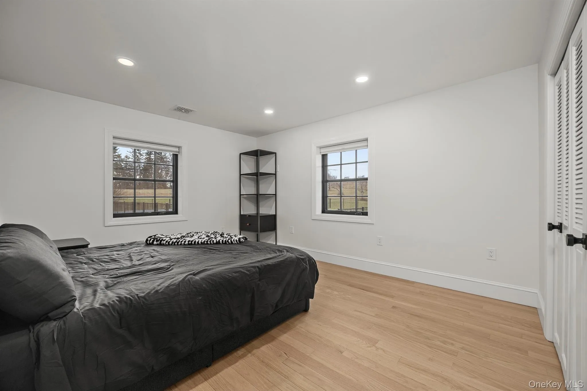 3rd bedroom featuring light wood flooring and recessed lighting 3rd bedroom featuring light wood flooring and recessed lighting