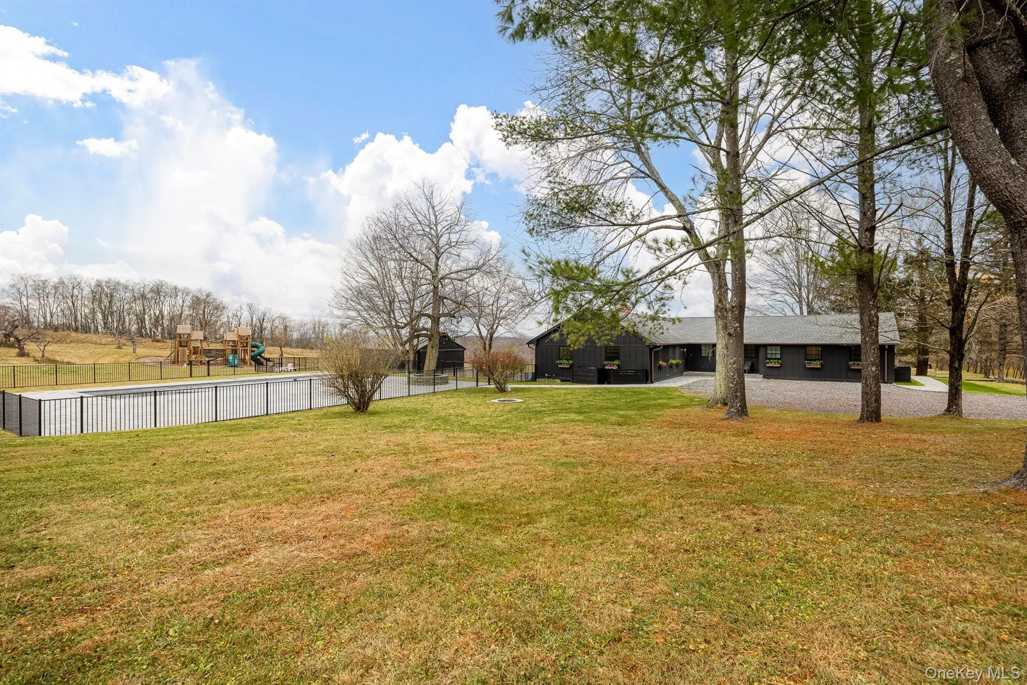 View of yard with an in-ground pool and playground View of yard with an in-ground pool and playground