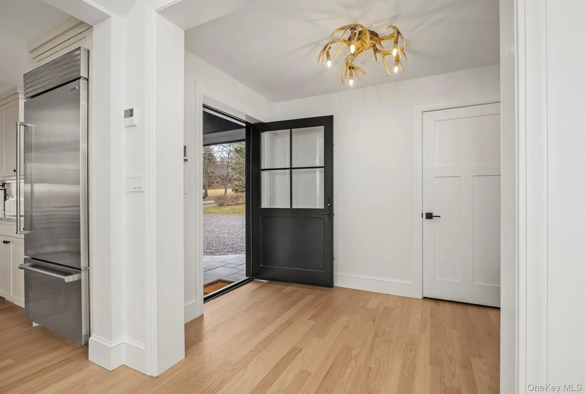 Entryway featuring wood flooring and a chandelier Entryway featuring wood flooring and a chandelier