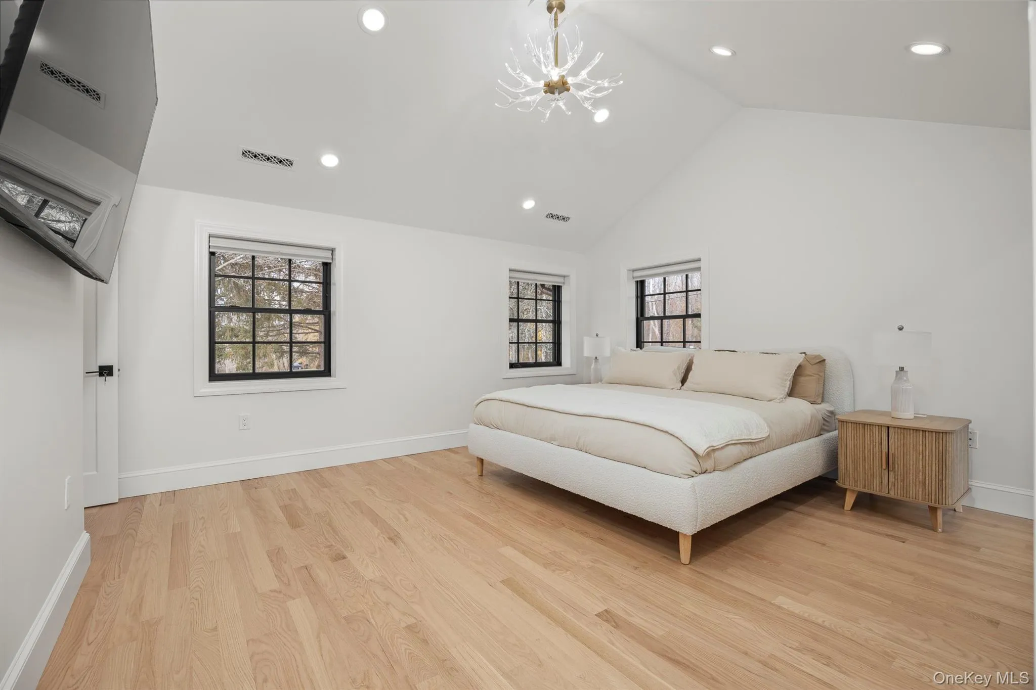 Primary bedroom featuring wood flooring, vaulted ceiling Primary bedroom featuring wood flooring, vaulted ceiling